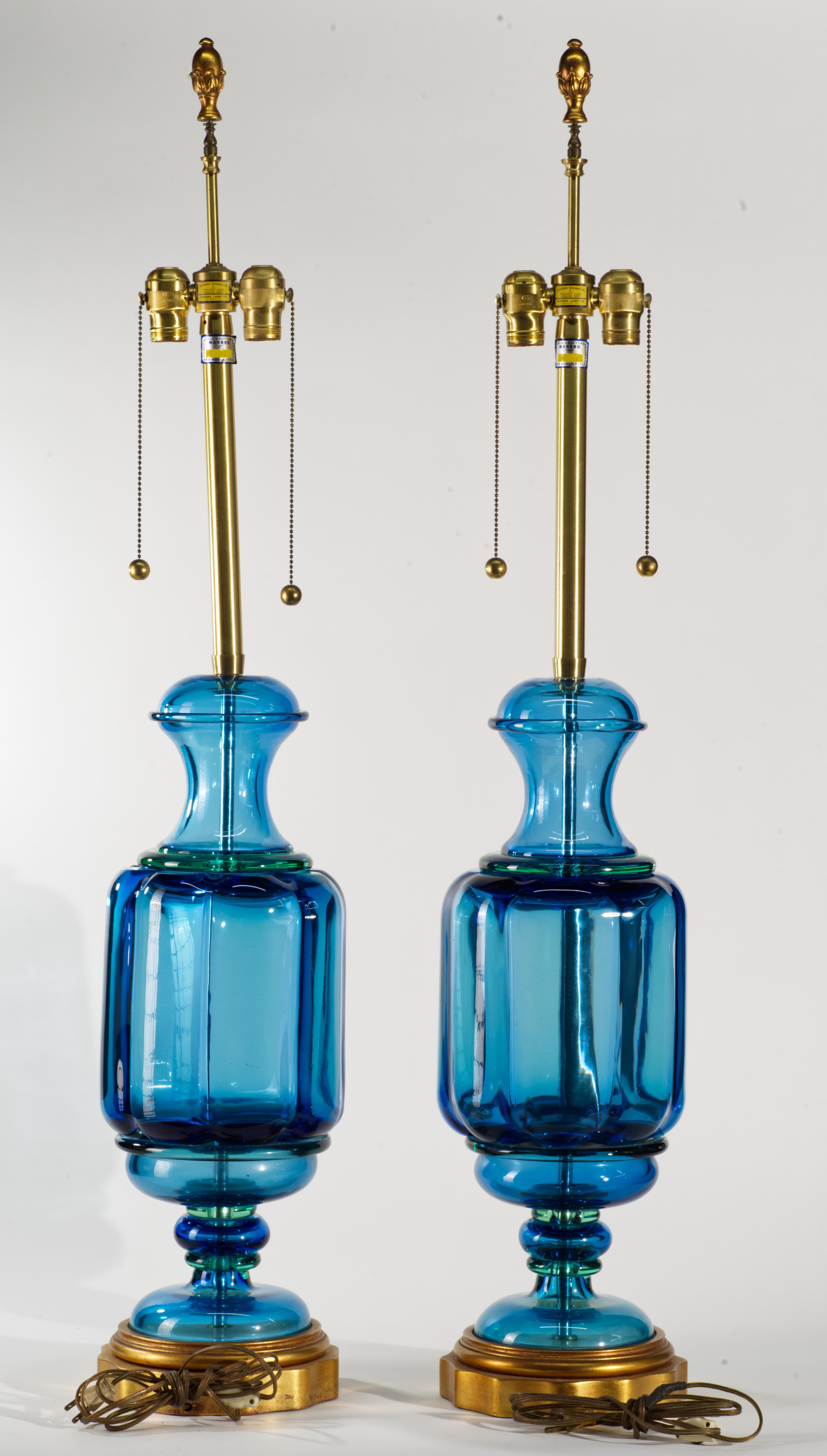  Stunning sculptural Murano glass lamps feature extra-large hand-blown glass bodies, assembled from multiple separate parts and mounted on gilded wood bases with brass fittings. The main glass elements have a complex shape that is reflected in the