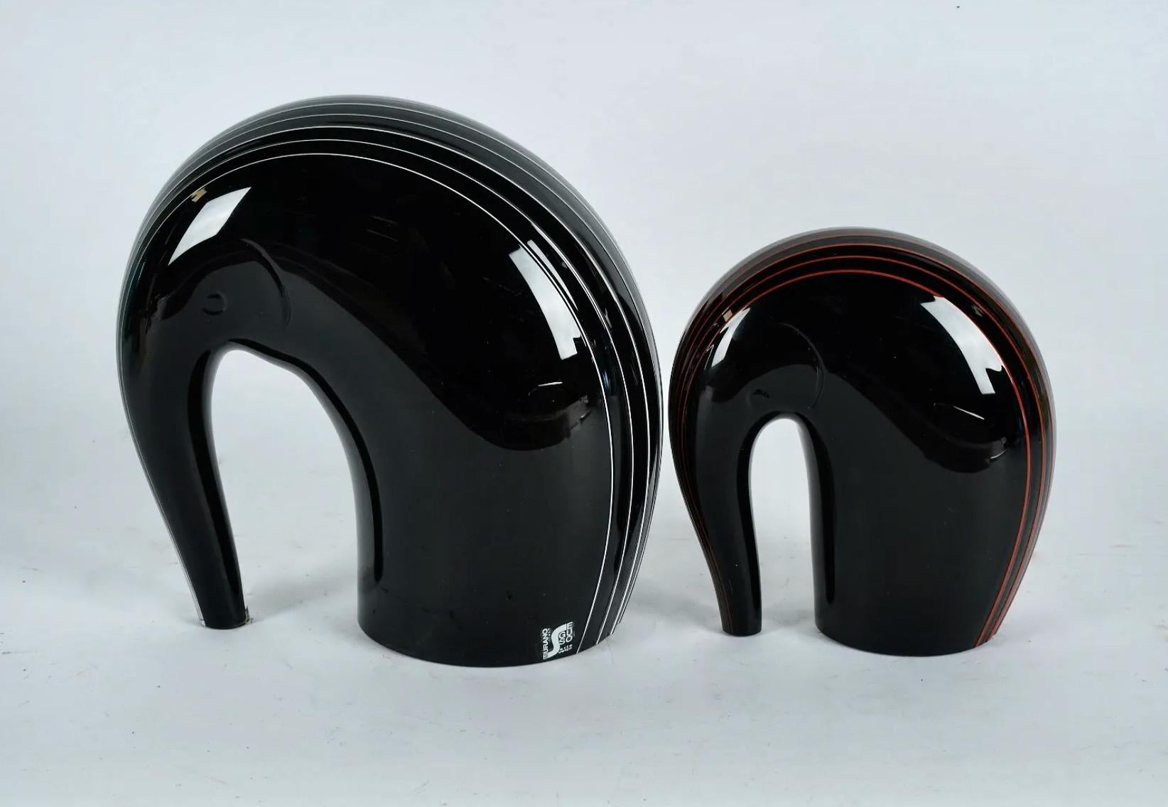 This is a wonderful sculptural grouping of a mother elephant and calf that dates to the mid 20th century. Both sculptures are in overall very good condition with no faults noted. Both pieces are signed. The quality of abstract design brings these