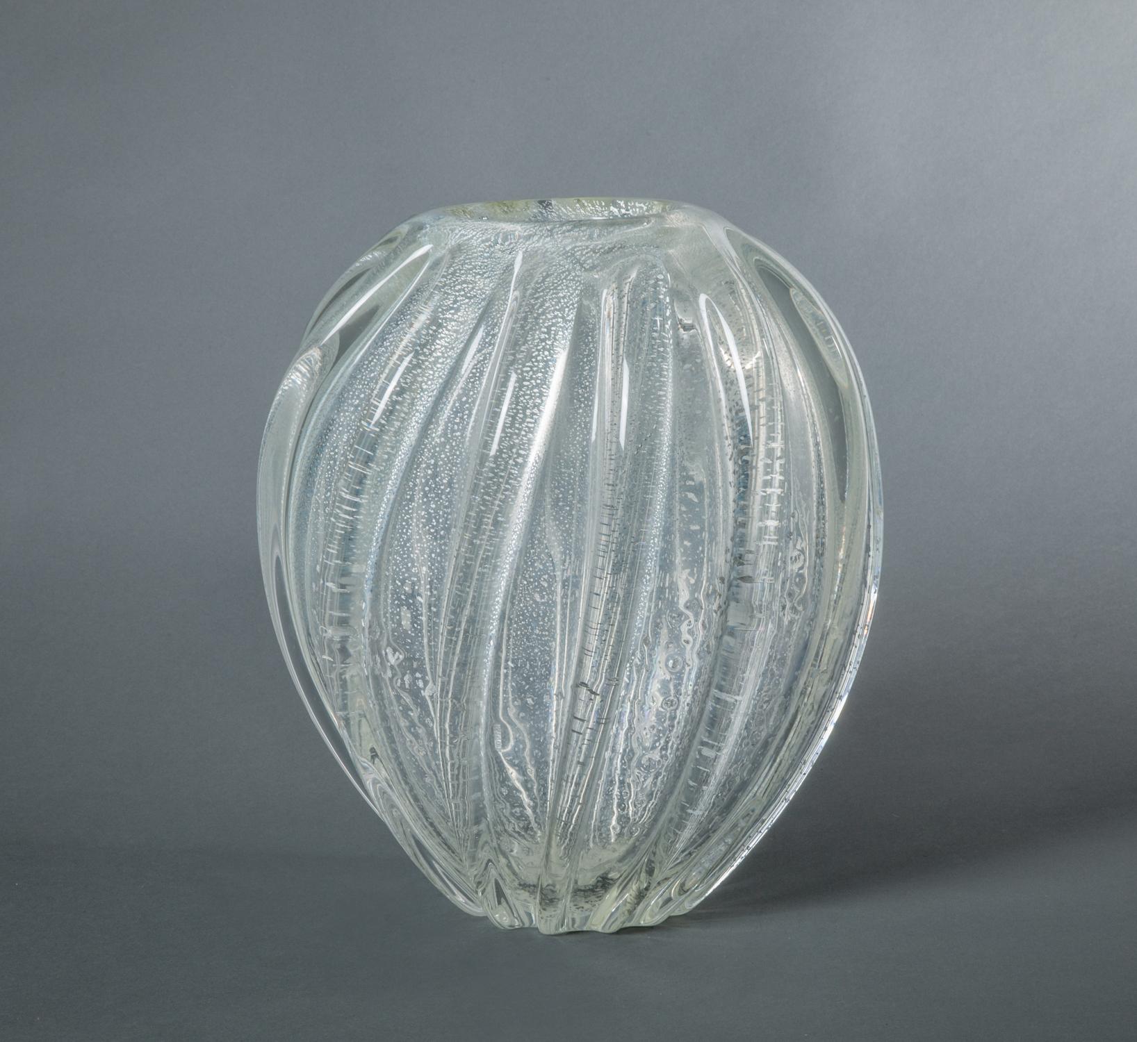 Seguso Murano Italian glass vase, beautiful twisted fluted design with silver leaf suspended in the glass. The thickness of the glass allows this vase to hold your top-heavy flowers like peonies. Marked Seguso Murano on the bottom.
  
