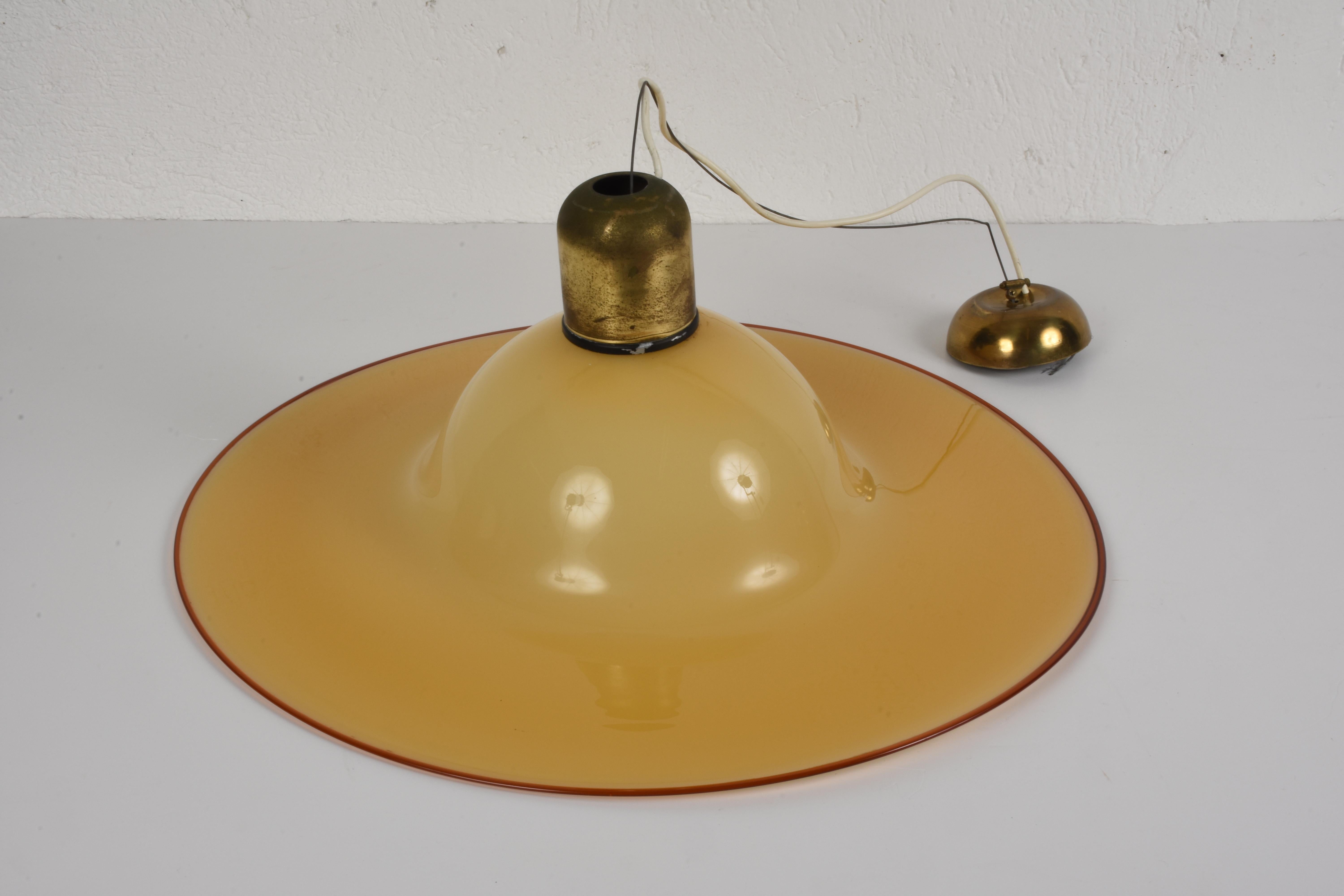 Very elegant bell form amber hand blown Murano glass chandelier, produced by Murano glass master Archimede Seguso.

The item is a Classic midcentury designed chandelier and comes with a stylized brass ring top canopy and fabric coiled cord. The