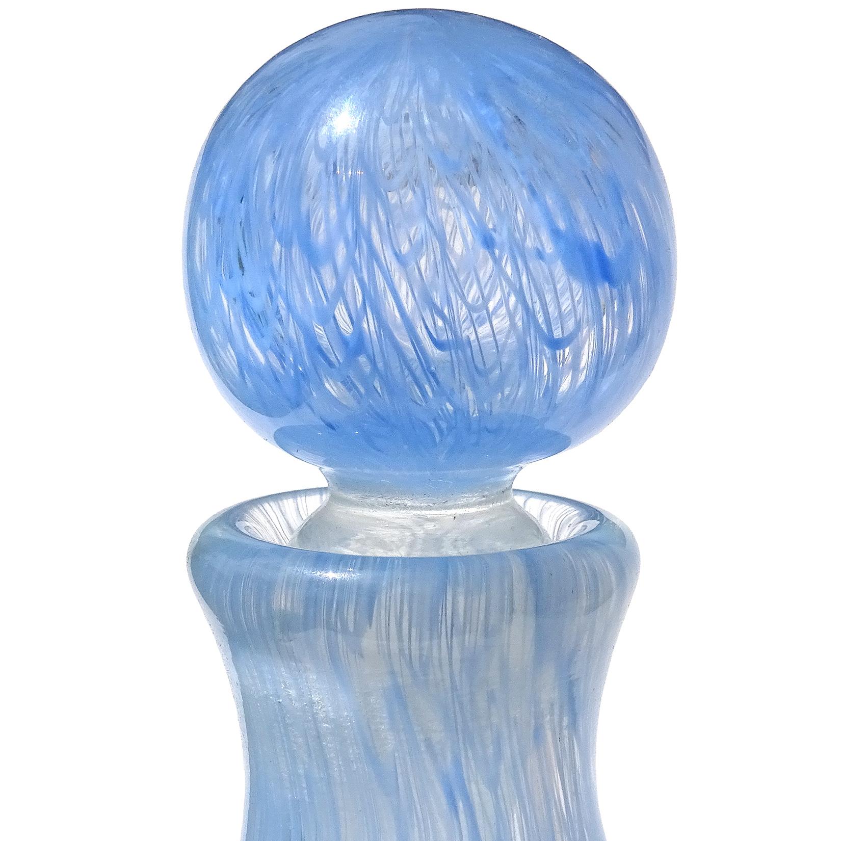 Beautiful and rare, vintage Murano hand blown blue ribbons Italian art glass vanity perfume bottle. Documented to designer Archimede Seguso, in the Merletto design, circa 1954. The color is a light sky blue. The perfume still has the original