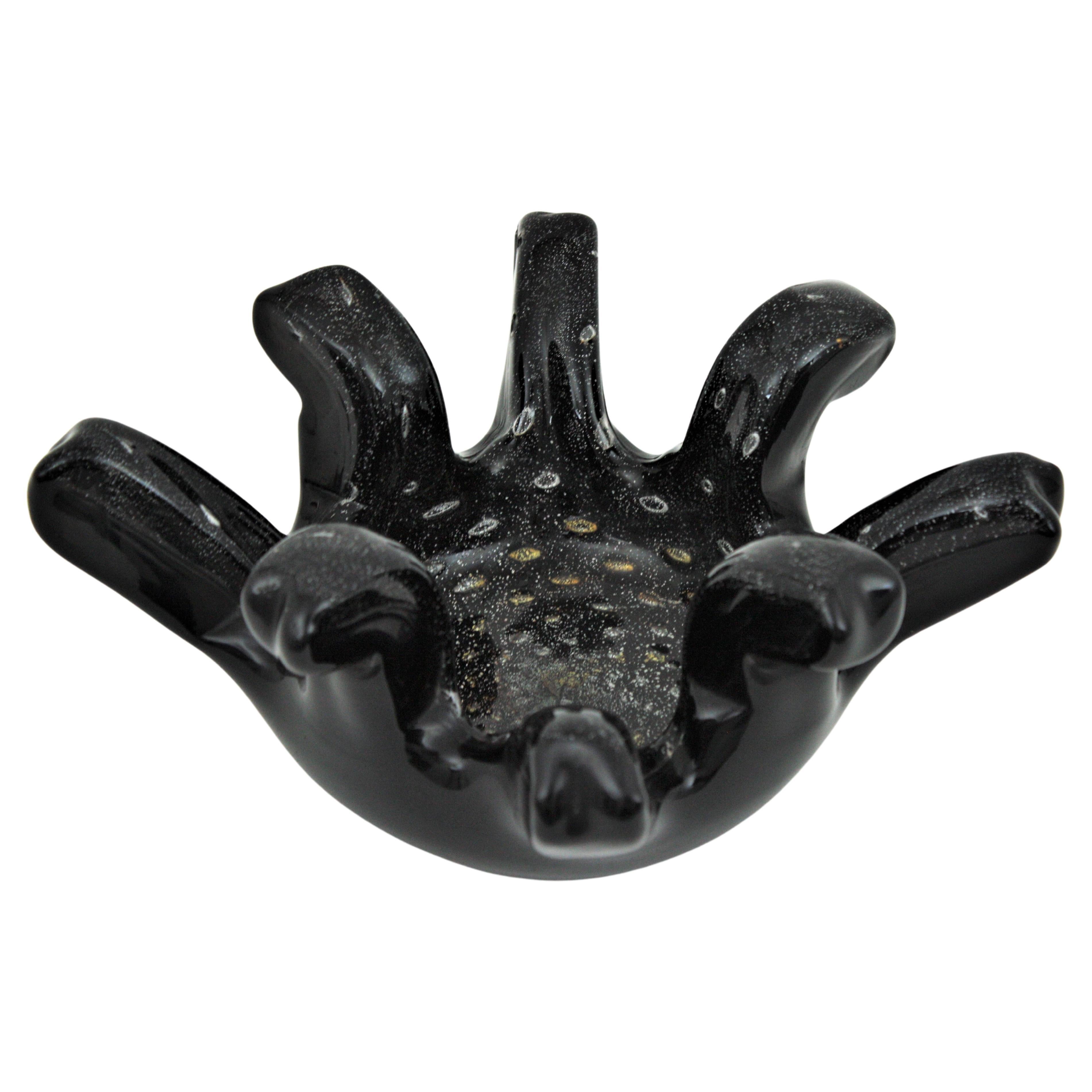 Black Murano glass centerpiece bowl with silver and gold flecks. Attributed to Seguso Vetri d'Arte factory, Italy, 1950s
This large hand blown bowl or centerpiece is made in black glass with gold and silver dust inclusions and it has decorative air