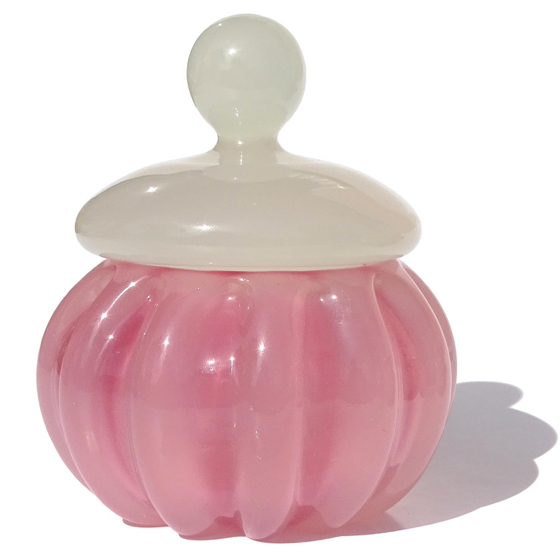 Beautiful vintage Murano hand blown opalescent blush pink and white Italian art glass vanity jar / powder box. Documented to designer Archimede Seguso, circa 1950s. The lid is made with a thick and opaque white opal glass. The body of the jar has a