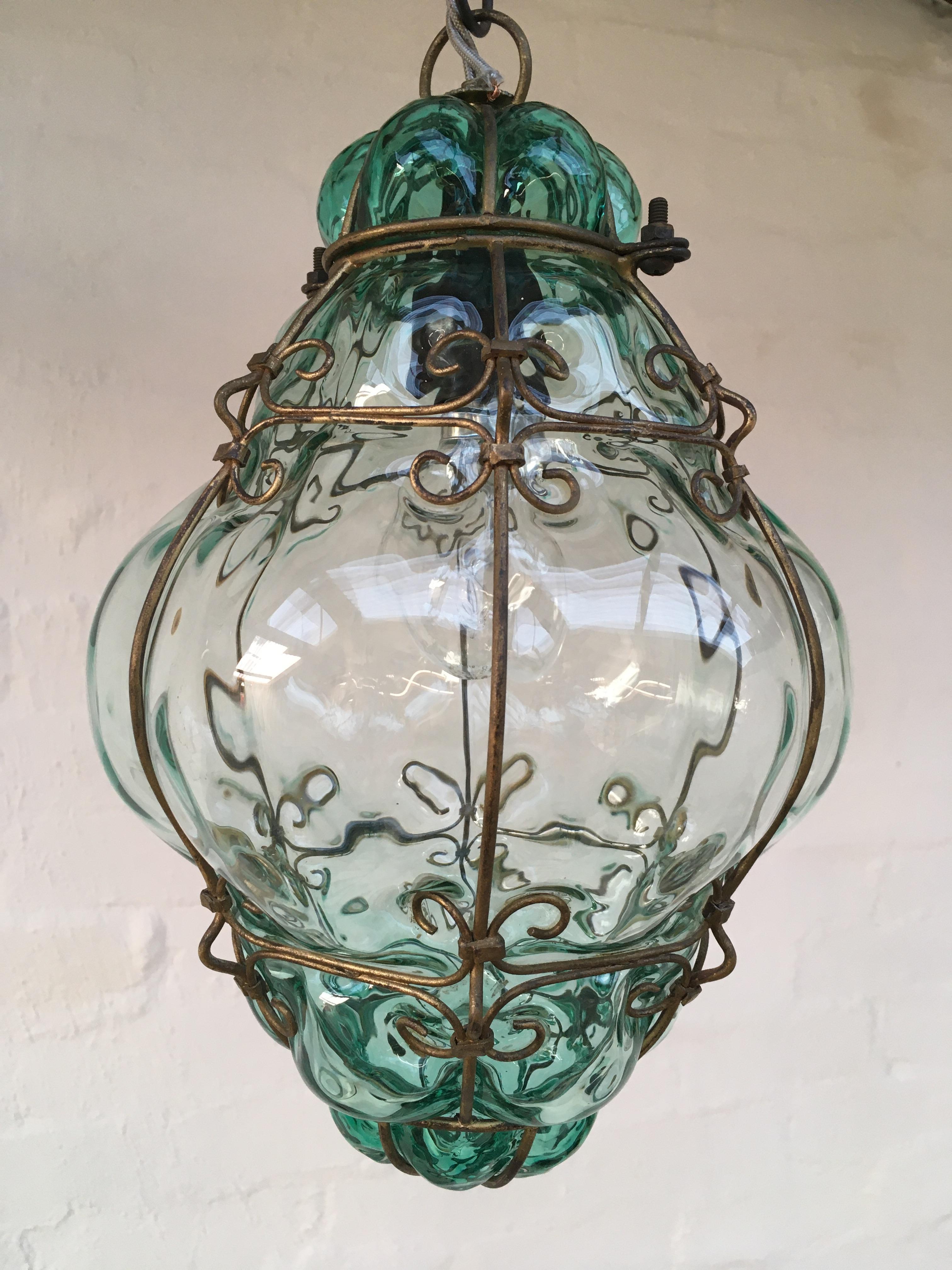 A lovely light for hallways and entrances. A hand blown Venetian glass lantern, attributed to Seguso. 

It casts a beautiful rippling light pattern, like a fishing net, or the reflection of rippling water, on surrounding surfaces. The glass color is