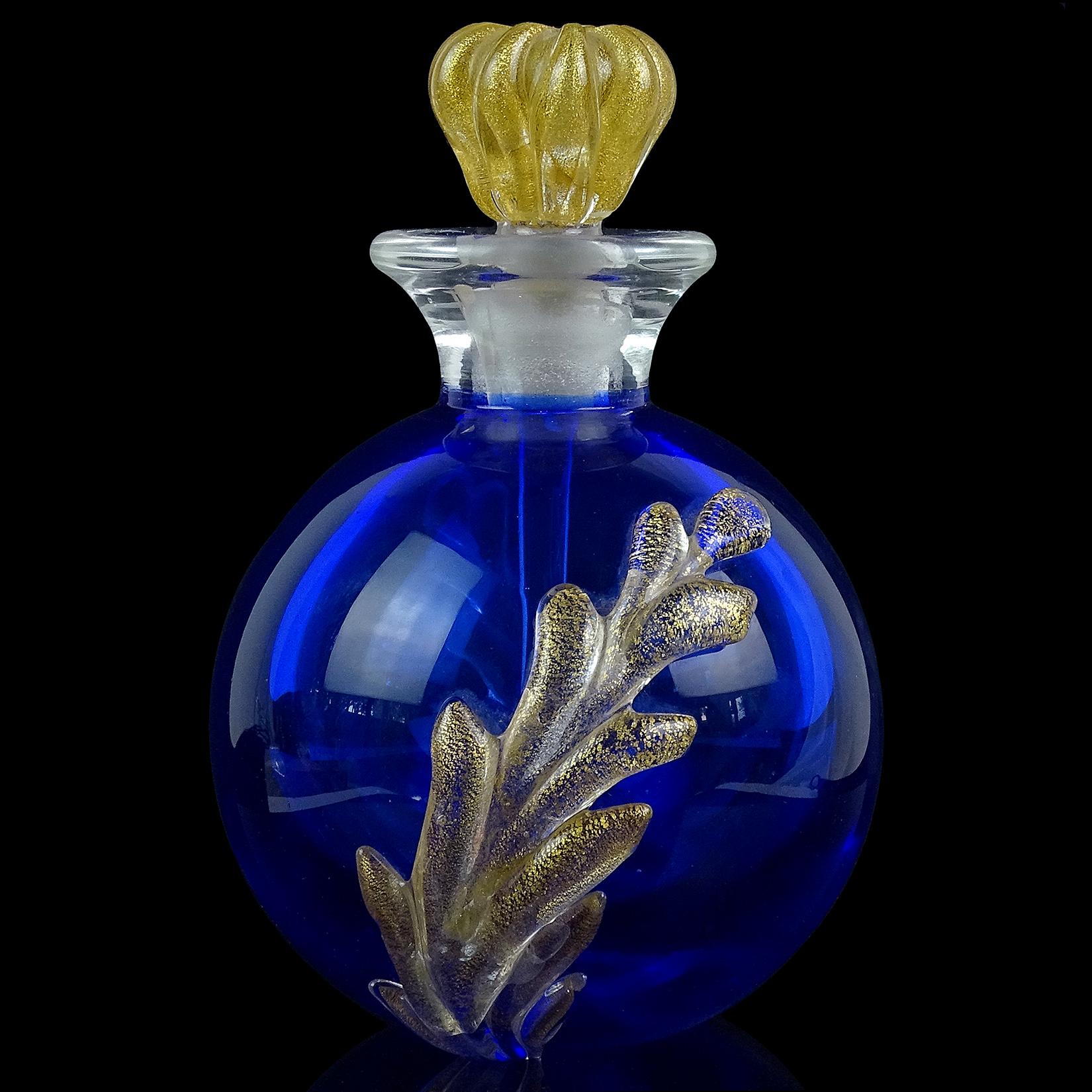 Beautiful vintage Murano hand blown Sommerso cobalt blue and gold flecks Italian art glass perfume bottle. Documented to designer Archimede Seguso, circa 1950s. A larger perfume, with a round shape and applied decoration. It has applied leafs and