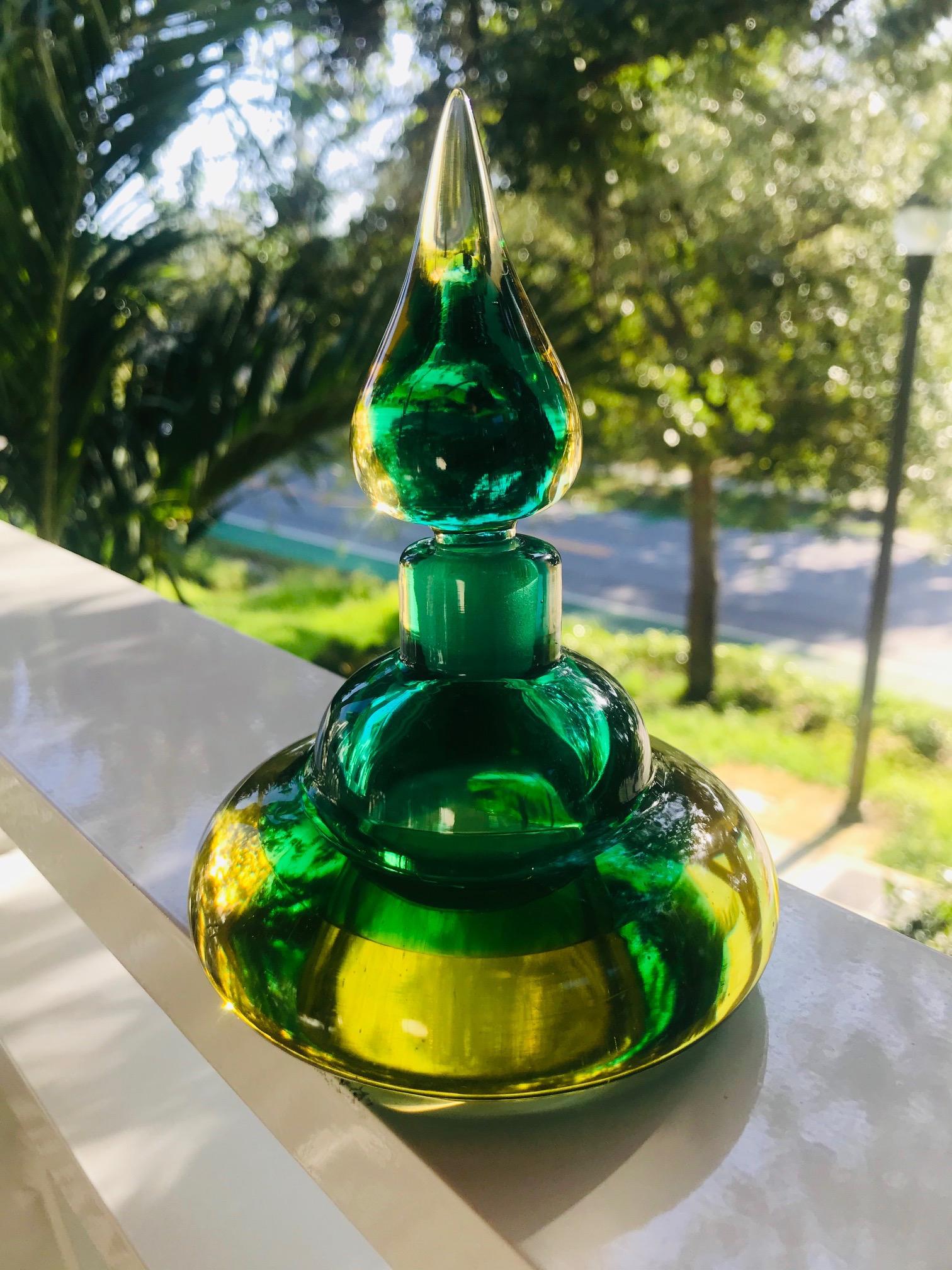 Mid-Century Modern decorative bottle or vintage perfume bottle in vibrant hues of emerald green and golden yellow. Beautifully handcrafted with sommerso technique featuring a stylized genie bottle design with a teardrop glass stopper, reminiscent of