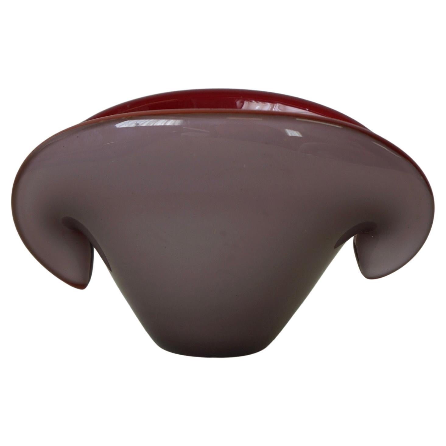 Two toned purple/grape and red Archimede Seguso clam shaped decorative bowl made by Murano. This striking decorative art glass is a well known design by Archimede Seguso made in the 1960s in Murano, Italy. The outside is a dull purple tone while the