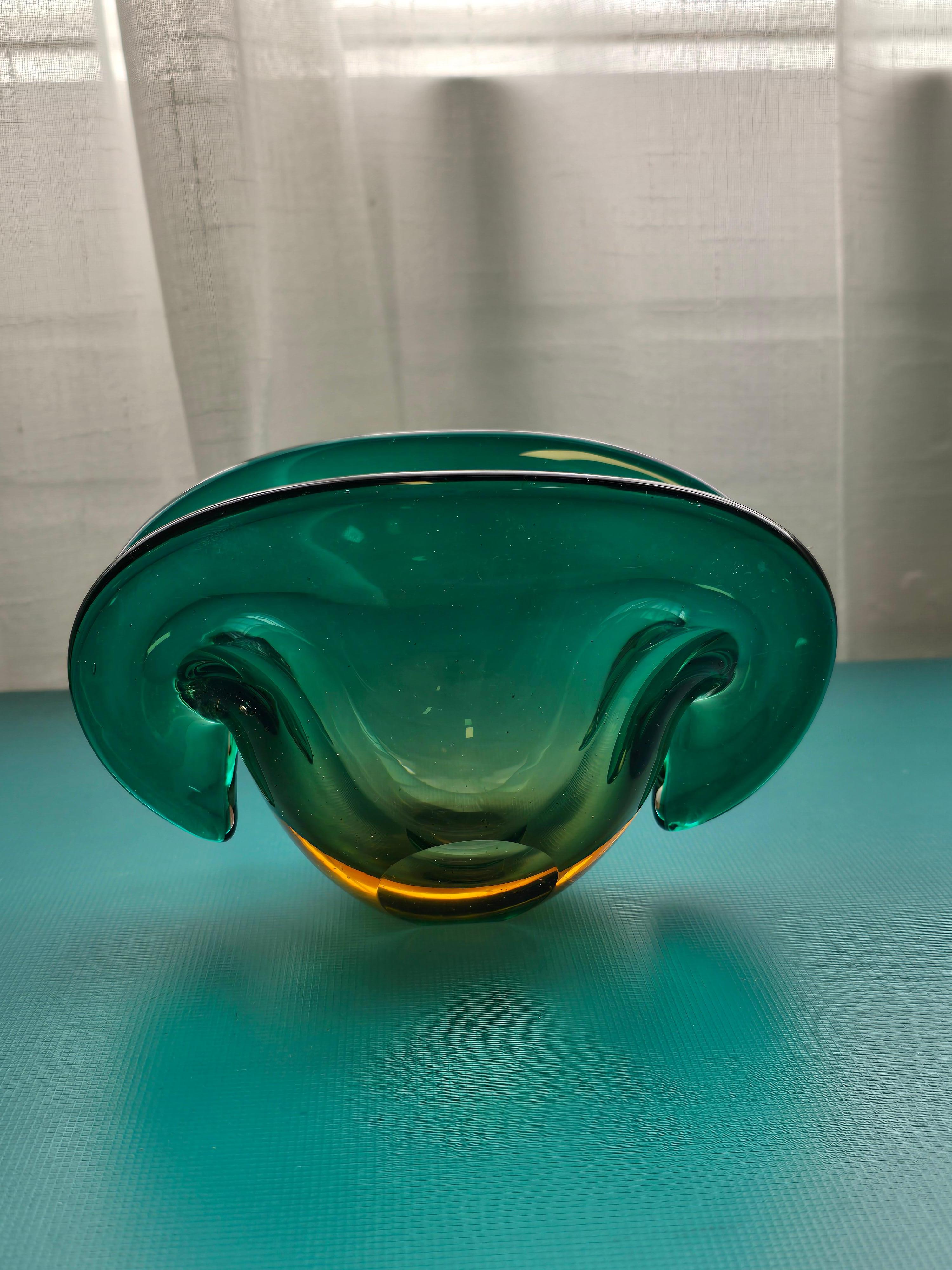 Transparent blue green art glass Archimede Seguso decorative bowl made by Murano. This striking decorative bowl resembles the shape of a clam. It was designed by Archimede Seguso and made in the 1960s in Murano, Italy. The transparent art glass