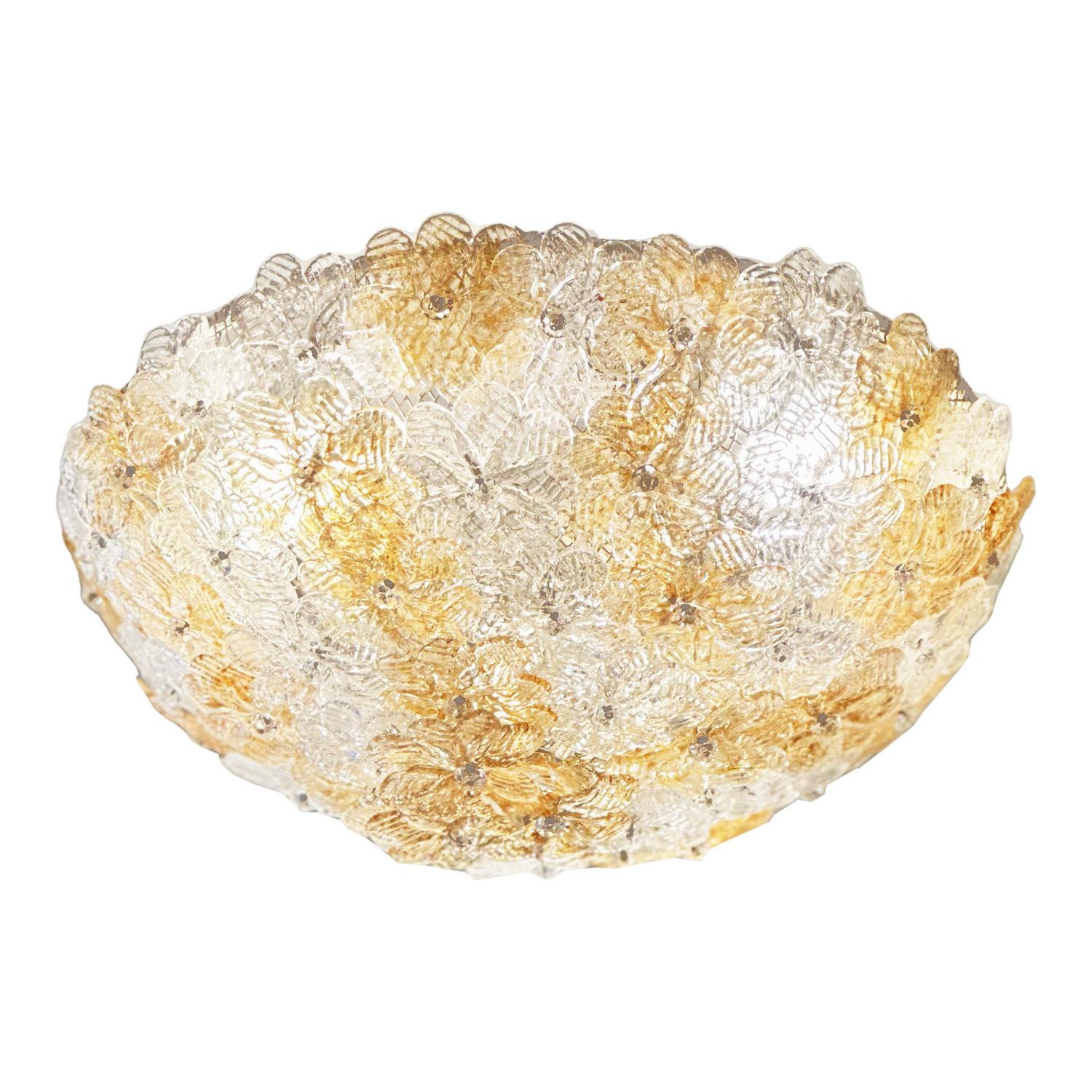 Where as a light composed of glass flowers has the potential to appear kitsch, this charming ceiling fixture made in the 1960s by Seguso is anything but. It’s crucible-shaped design is adorned with a delicate bouquet of amber and clear impressed