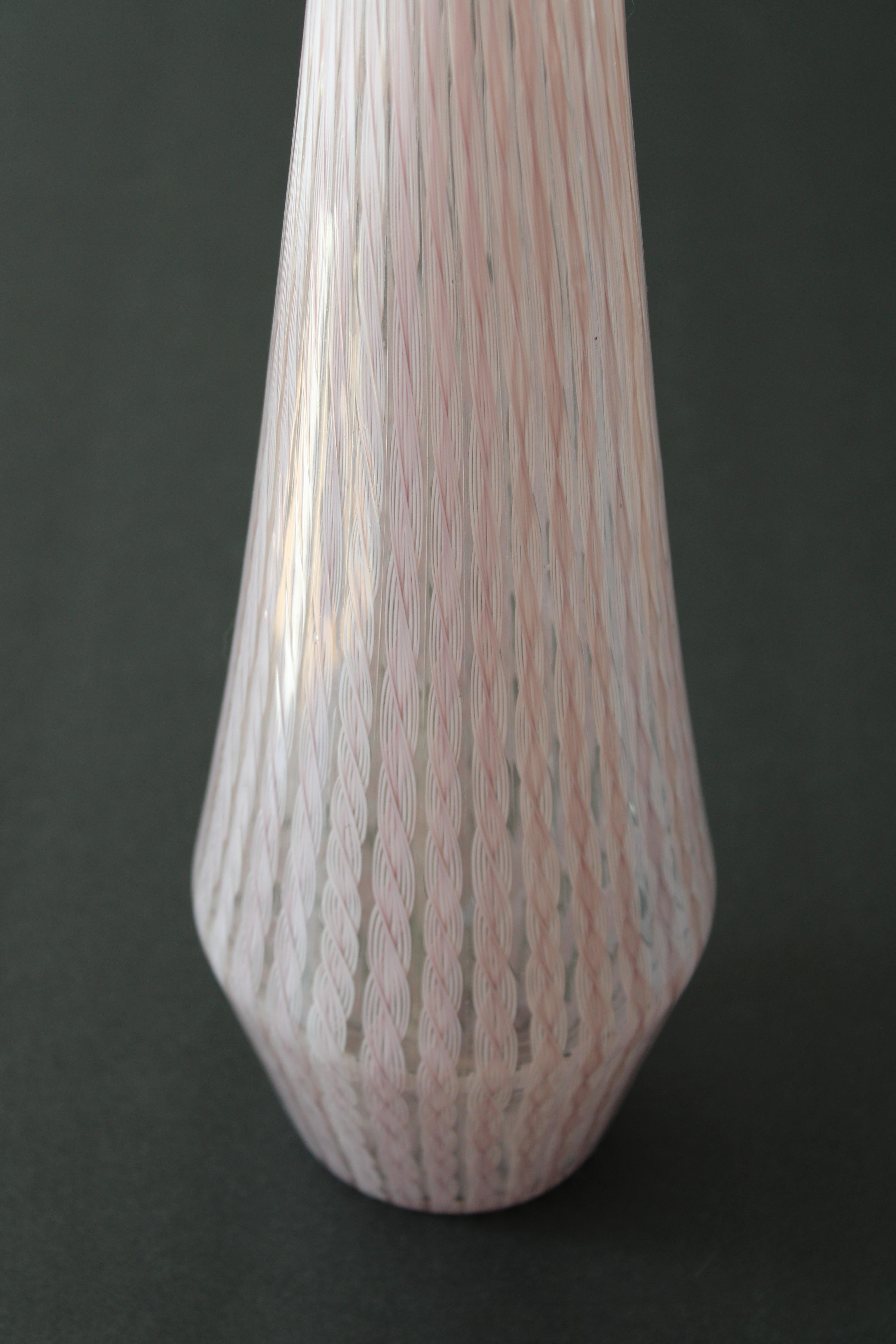 Murano vase with a violet and white criss cross pattern.  Vase contains label that says Murano Glass Made in Italy.  Vase measures 15