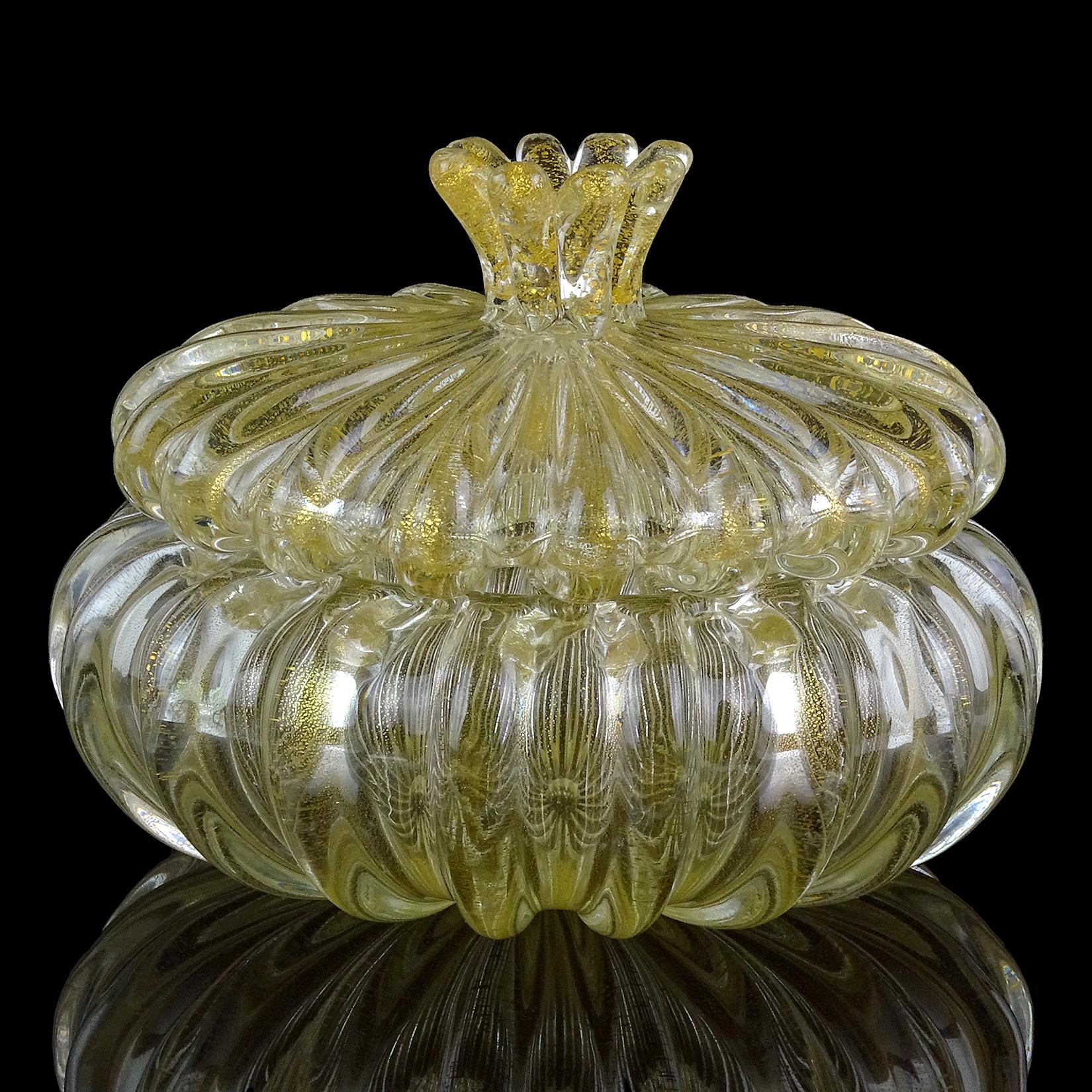 Elegant vintage Murano hand blown gold flecks Italian art glass vanity jewelry or powder box. Documented to designer Archimede Seguso. The entire piece is clear, and profusely covered in gold leaf. The lidded jar / box has a flower shape topper.