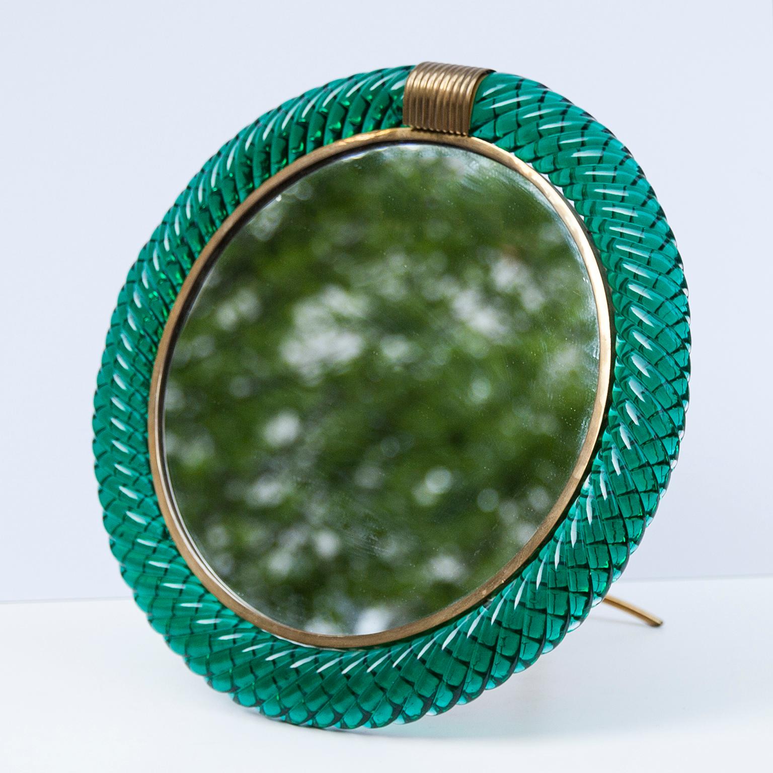 Elegant vanity mirror by Seguso Murano, Italy, circa 1970, green Murano glass frame, mirror framed in brass, wood mounted plate on the backside, brass stand.

 