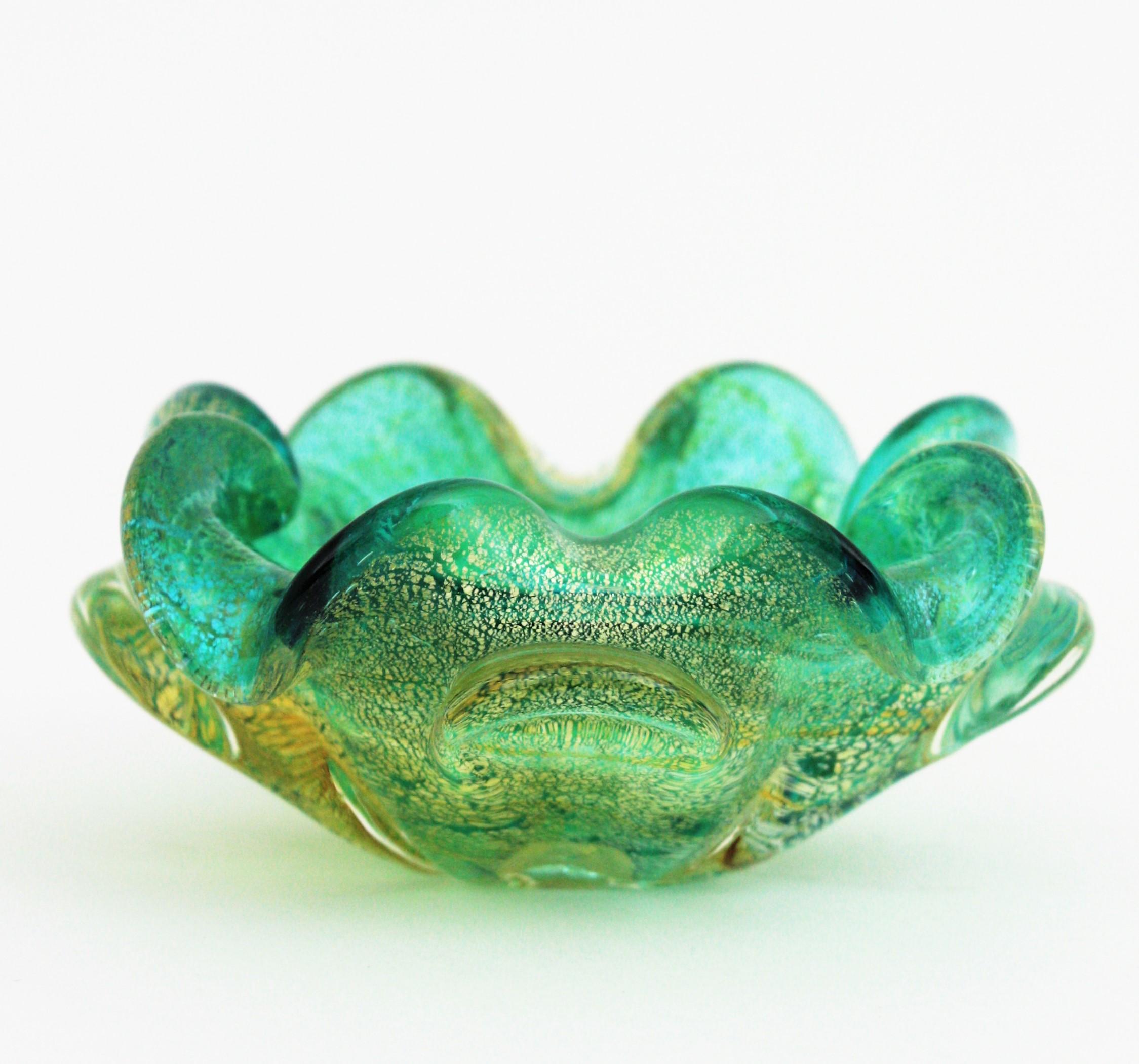 Lovely Murano blown glass bowl, Aqua Gree, Gold Leaf. Attributed to Seguso factory. Italy, 1950s
Green glass submerged into clear glass and covered by gold leaf inclussions at the exterior part.
Stunning color and unusual small size.
Perfect to