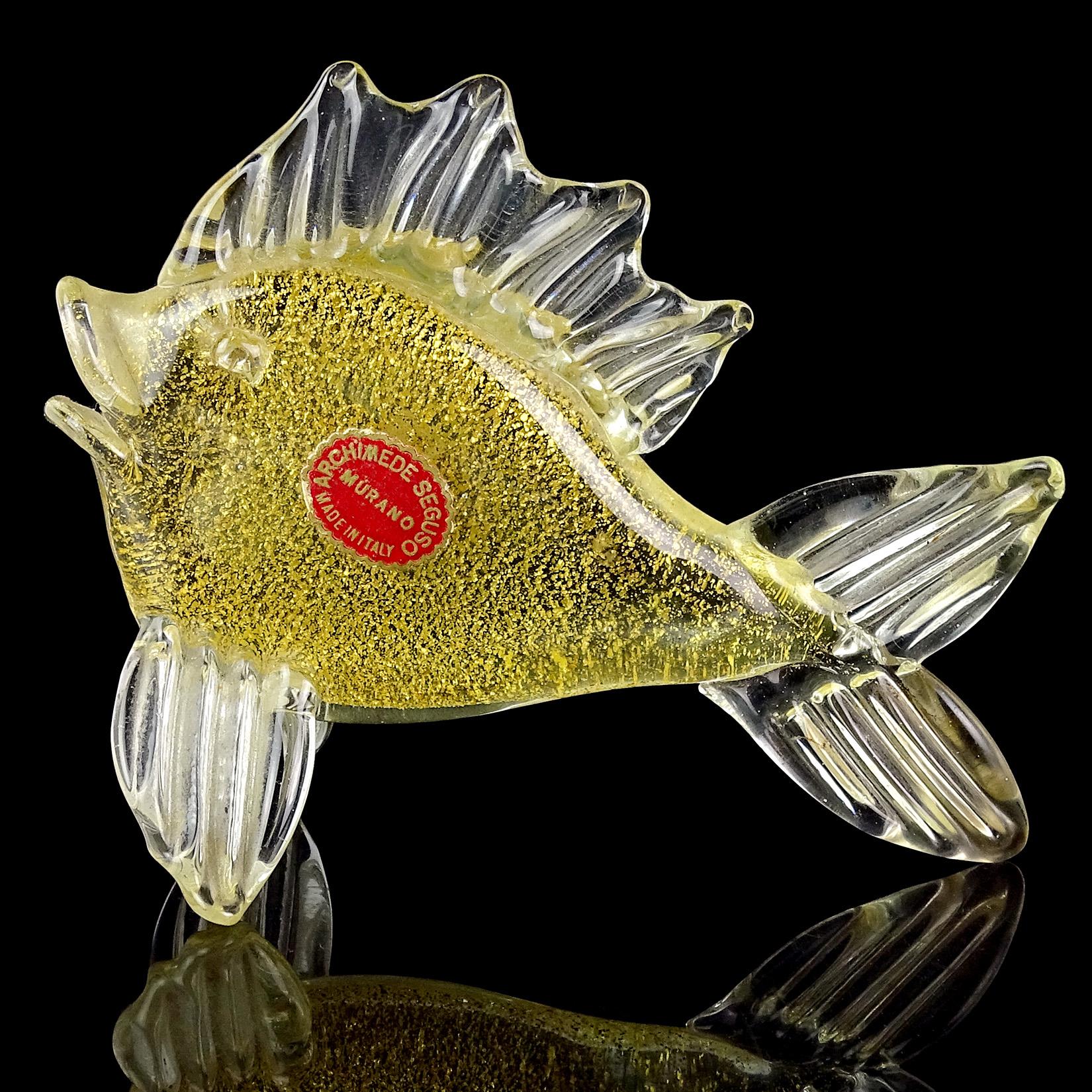 Beautiful vintage Murano hand blown clear and gold flecks Italian art glass fish sculpture / figurine. Documented to designer Archimede Seguso. The piece is profusely covered in gold leaf, with original label 