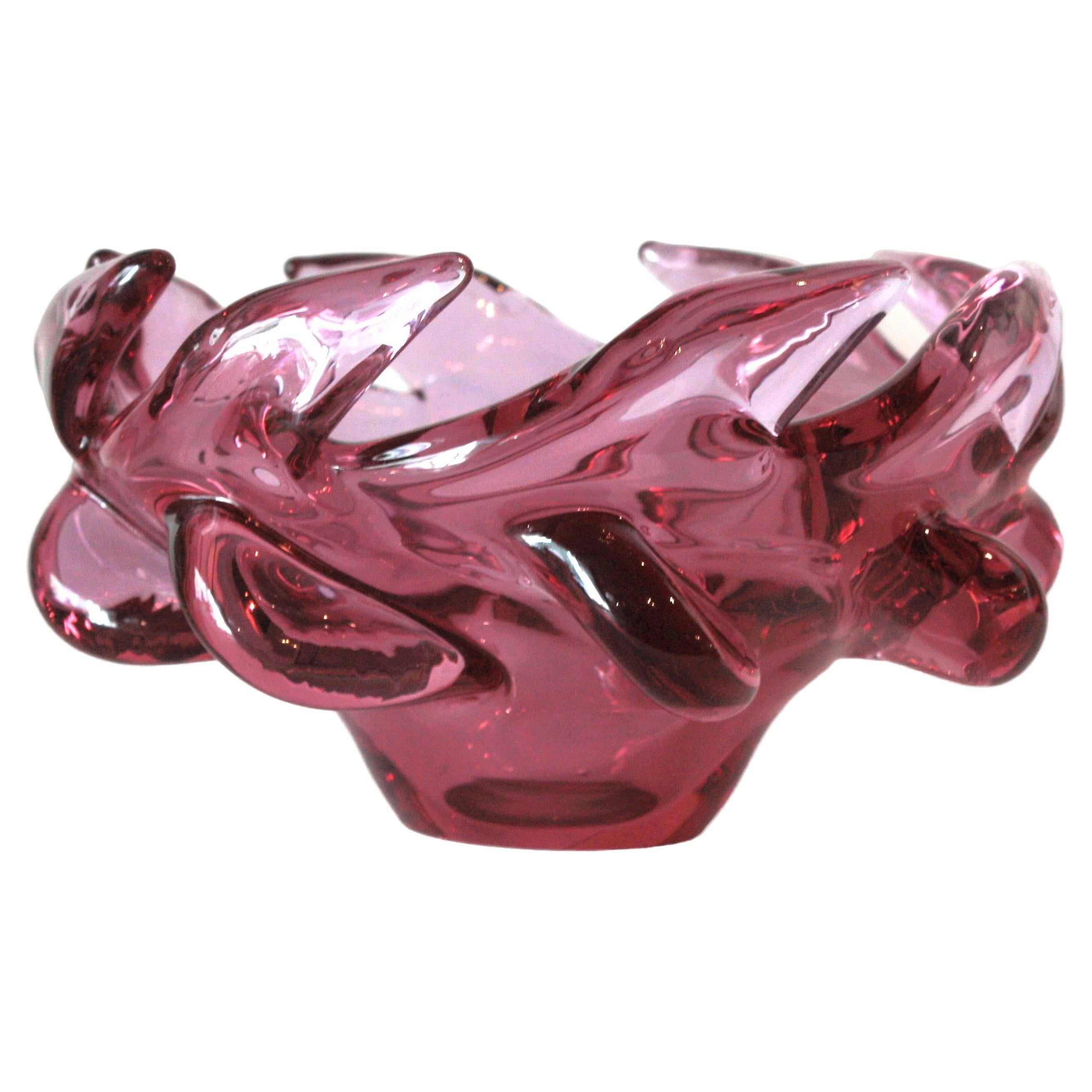Large hand blown pink Murano glass flower centerpiece bowl. Attributed to Archimede Seguso, Italy, 1950s.
This eye-catching bowl is made of hand blown pink purple glass with scalloped twisting rim and pulled details.
Lovely to be used as