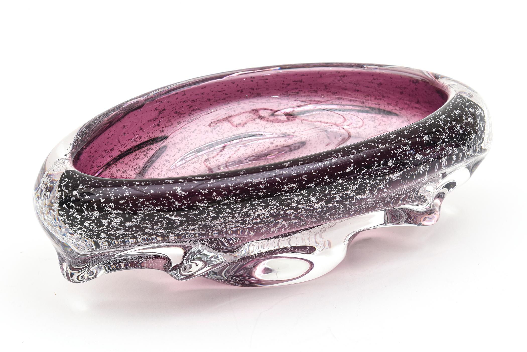 The gorgeous purple color and shape of this Italian vintage Murano Seguso oval hand blown glass bowl looks like a mini space ship with the hundreds of tiny bubbles inside that look like silver foil. The technique is called pulegoso. The clear