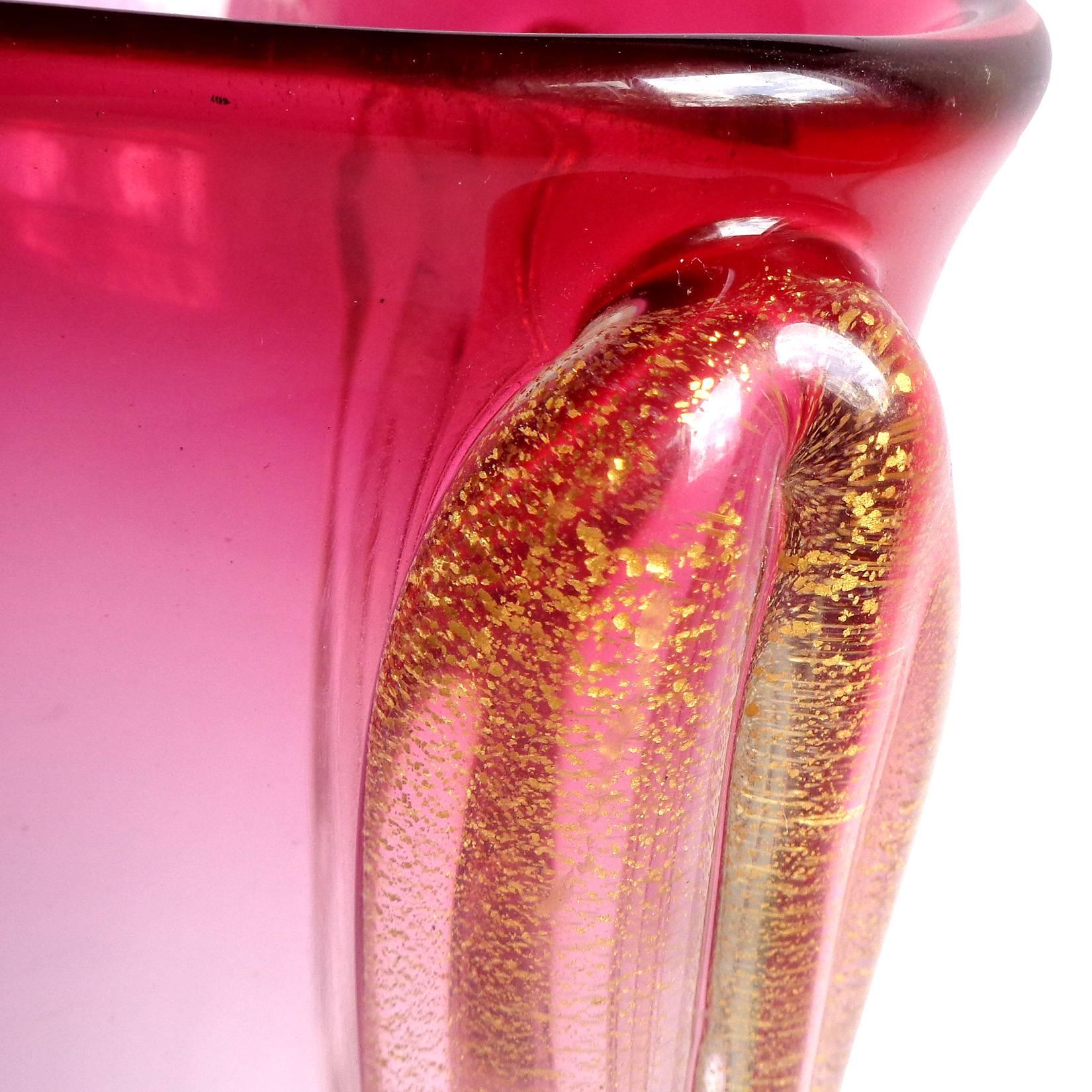 Gorgeous vintage Murano hand blown Sommerso red rim to pink and gold flecks Italian art glass flower vase. Attributed to designer Archimede Seguso. The piece has a triangular shape, with large gold leaf applied bands on each side. Would make a great