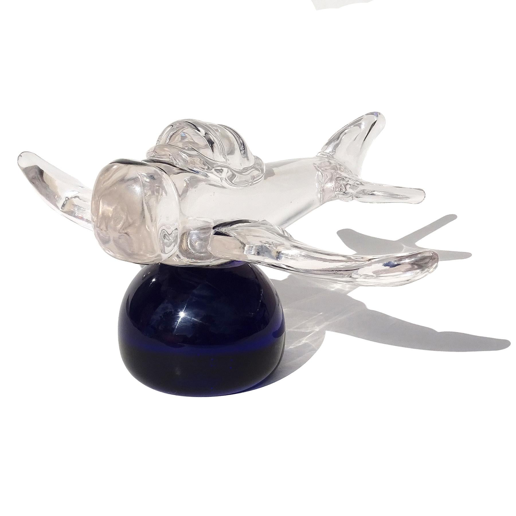 Beautiful and rare, vintage Murano hand blown Italian art glass crystal clear glass airplane on cobalt blue base sculpture. The plane is fully signed underneath, 