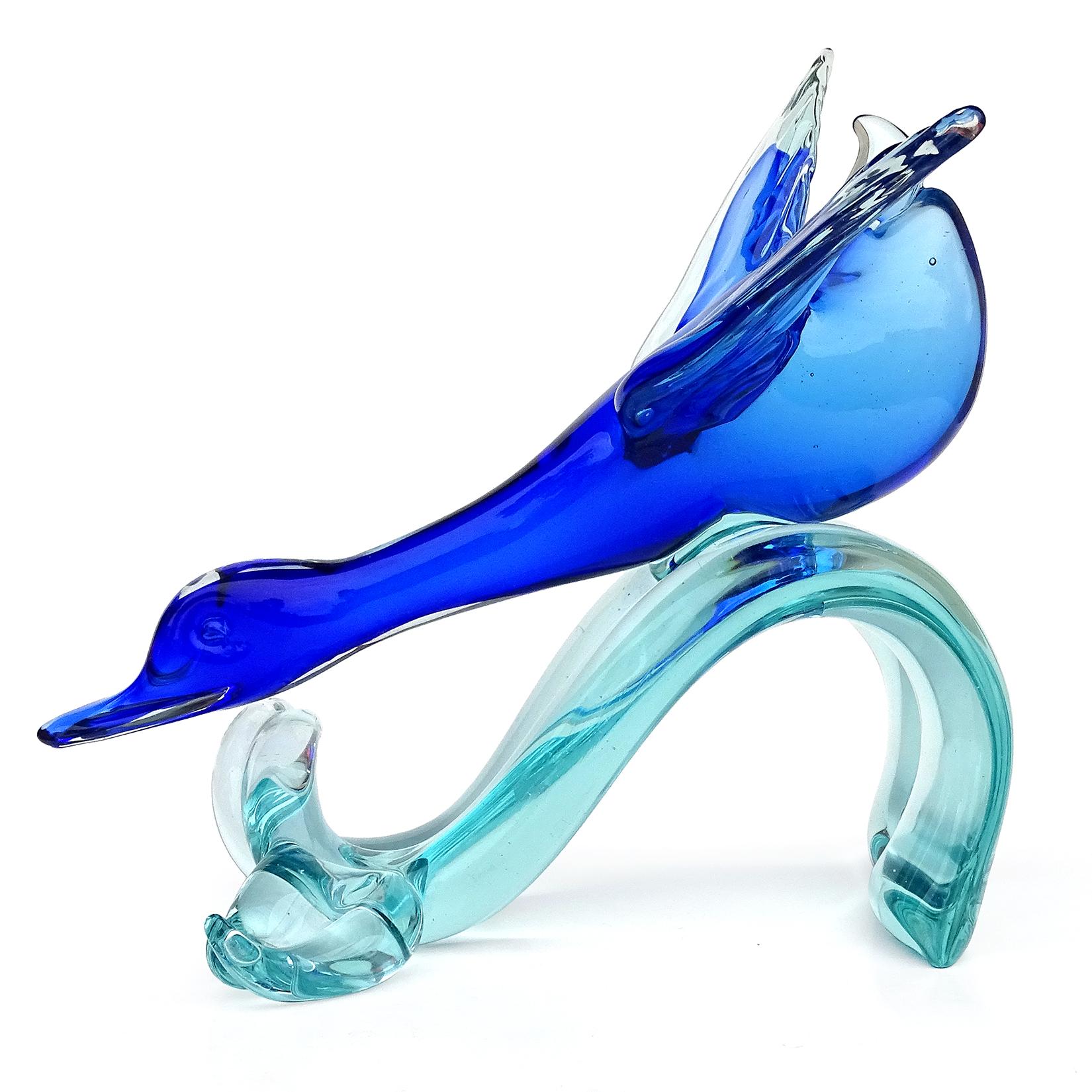 Beautiful and large, vintage Murano hand blown Sommerso cobalt to light blue, Italian art glass flying duck centerpiece sculpture. Documented to designer Archimede Seguso. The bird has its wings outstretched, in a nose dive coming in for a landing