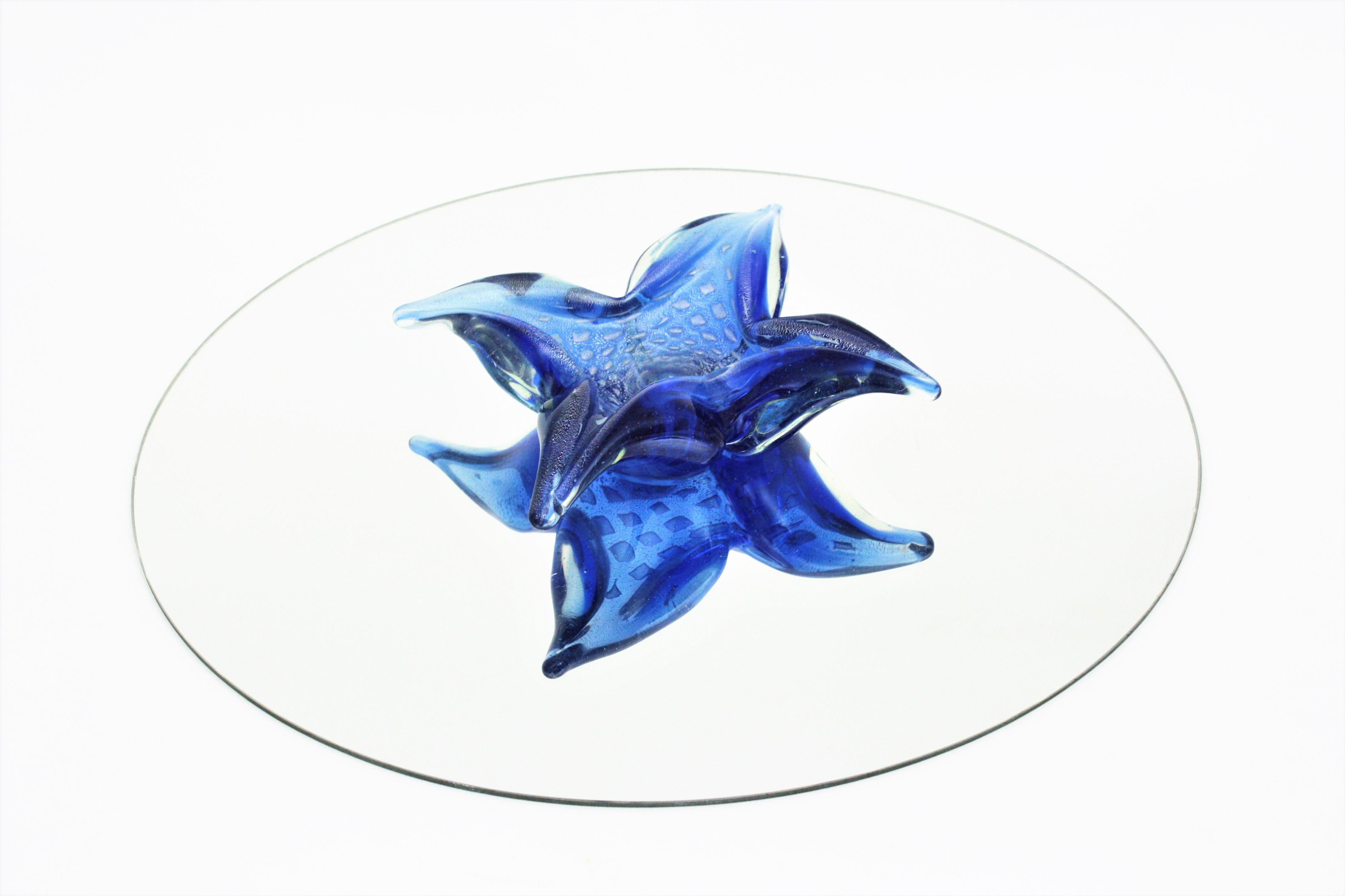 Crossshaped star / flower art glass bowl, murano glass, silver flecks. Attributed to Seguso, Italy, 1950-1960s.
Eye-catching hand blown cobalt blue Murano glass Sommerso bowl with controlled bubbles and aventurine technique with silver
