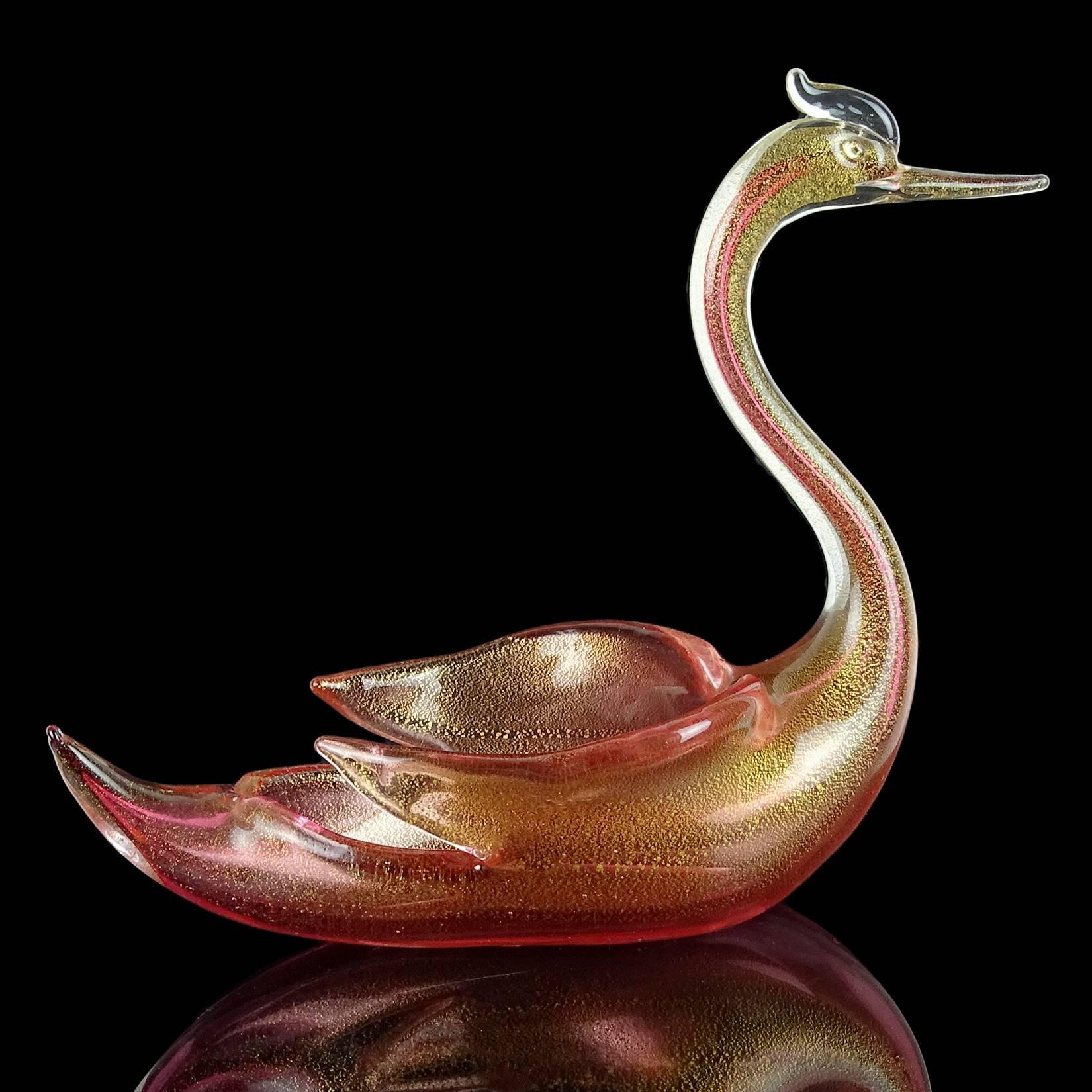 Beautiful, large vintage Murano hand blown Sommerso cranberry red and gold flecks Italian art glass cormorant sea bird bowl/vase. Documented to designer Archimede Seguso. The piece is profusely covered in gold leaf. Can be used as a display