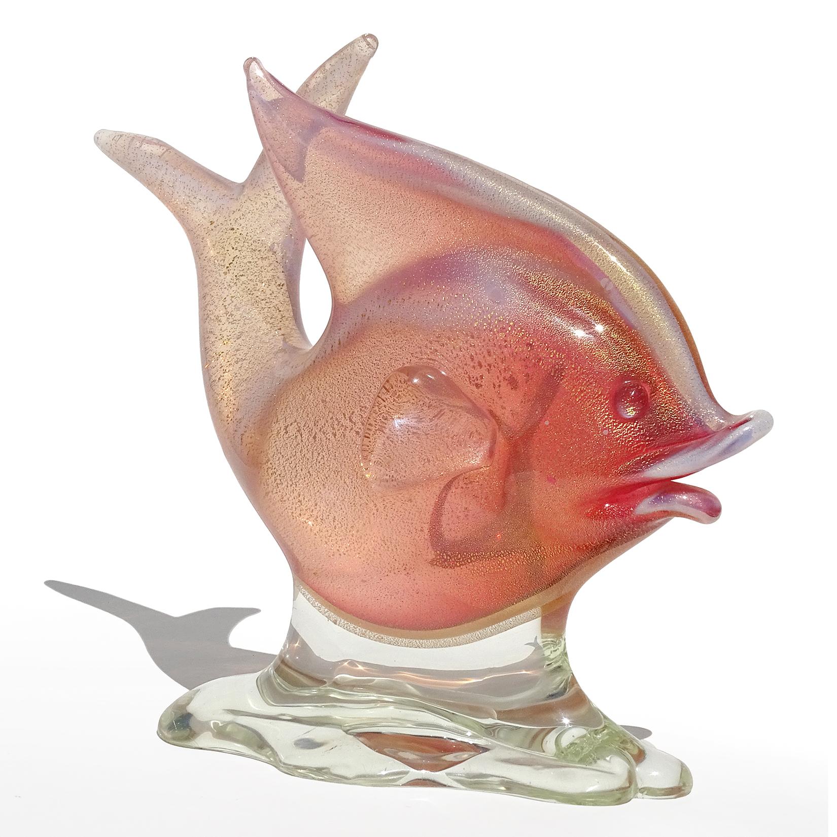 Beautiful vintage Murano hand blown Sommerso pink, opal and gold flecks Italian art glass fish on clear pedestal sculpture. Documented to designer Archimede Seguso, circa 1950s. The opalescent glass creates an outline around the fish. Nicely