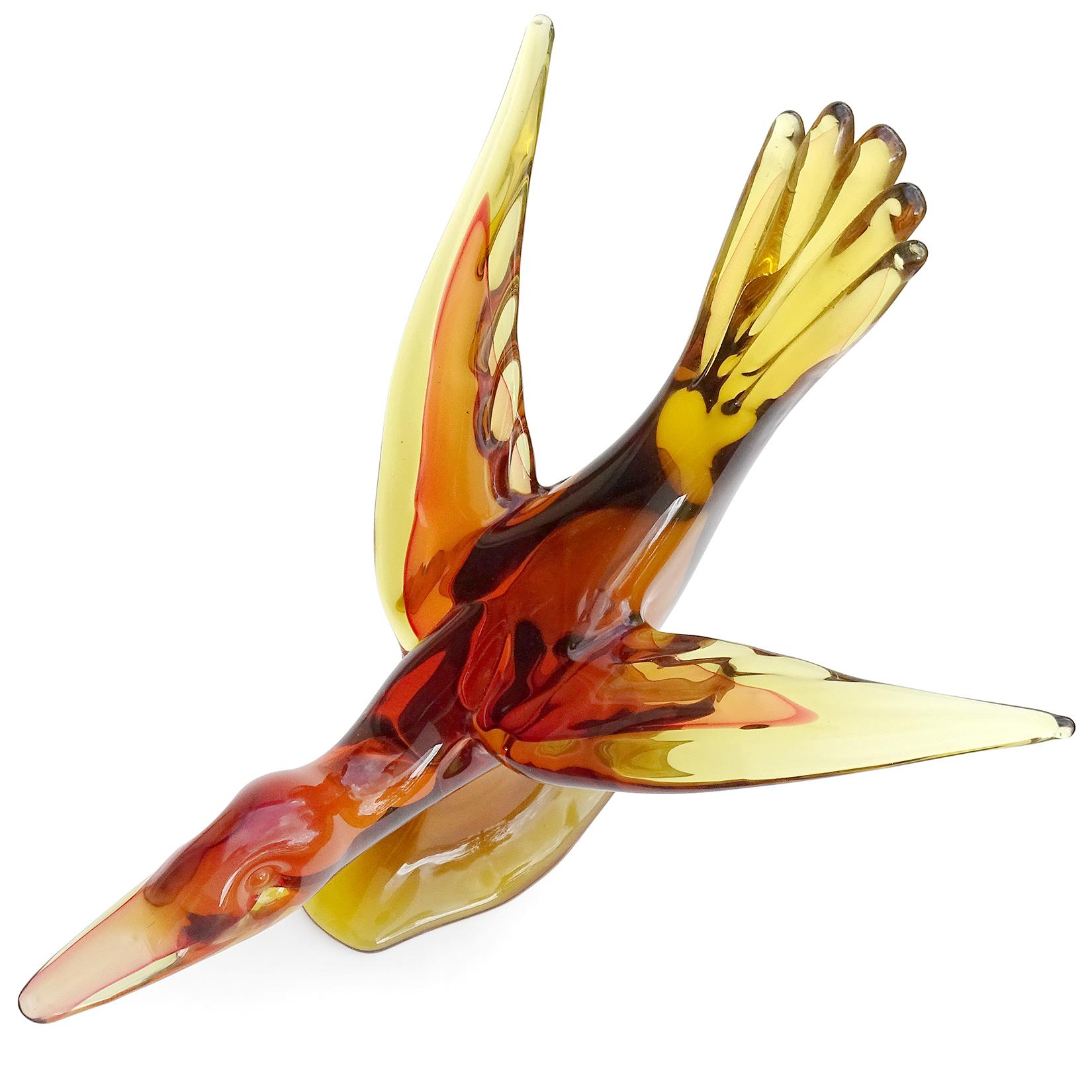 Beautiful, extra large, vintage Murano hand blown Sommerso golden yellow, orange over red, Italian art glass flying duck centerpiece sculpture. Documented to designer Archimede Seguso. The bird is substantial, and has its wings outstretched with