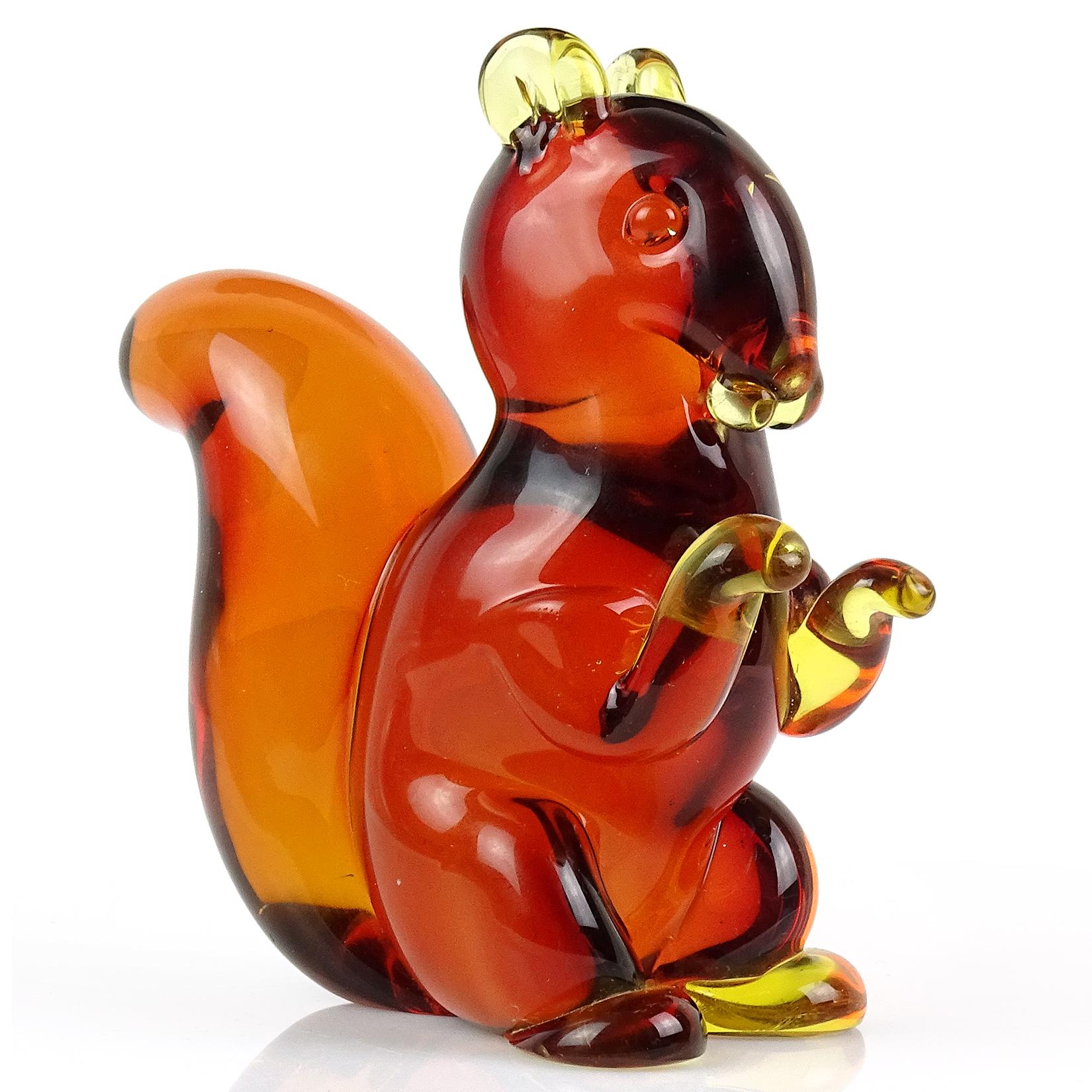 Beautiful and very cute, vintage Murano hand blown Sommerso red orange, yellow Italian art glass squirrel sculpture / figurine. Documented to designer Archimede Seguso. The red is mainly on its body, and the tail is orange. You can see the overlay