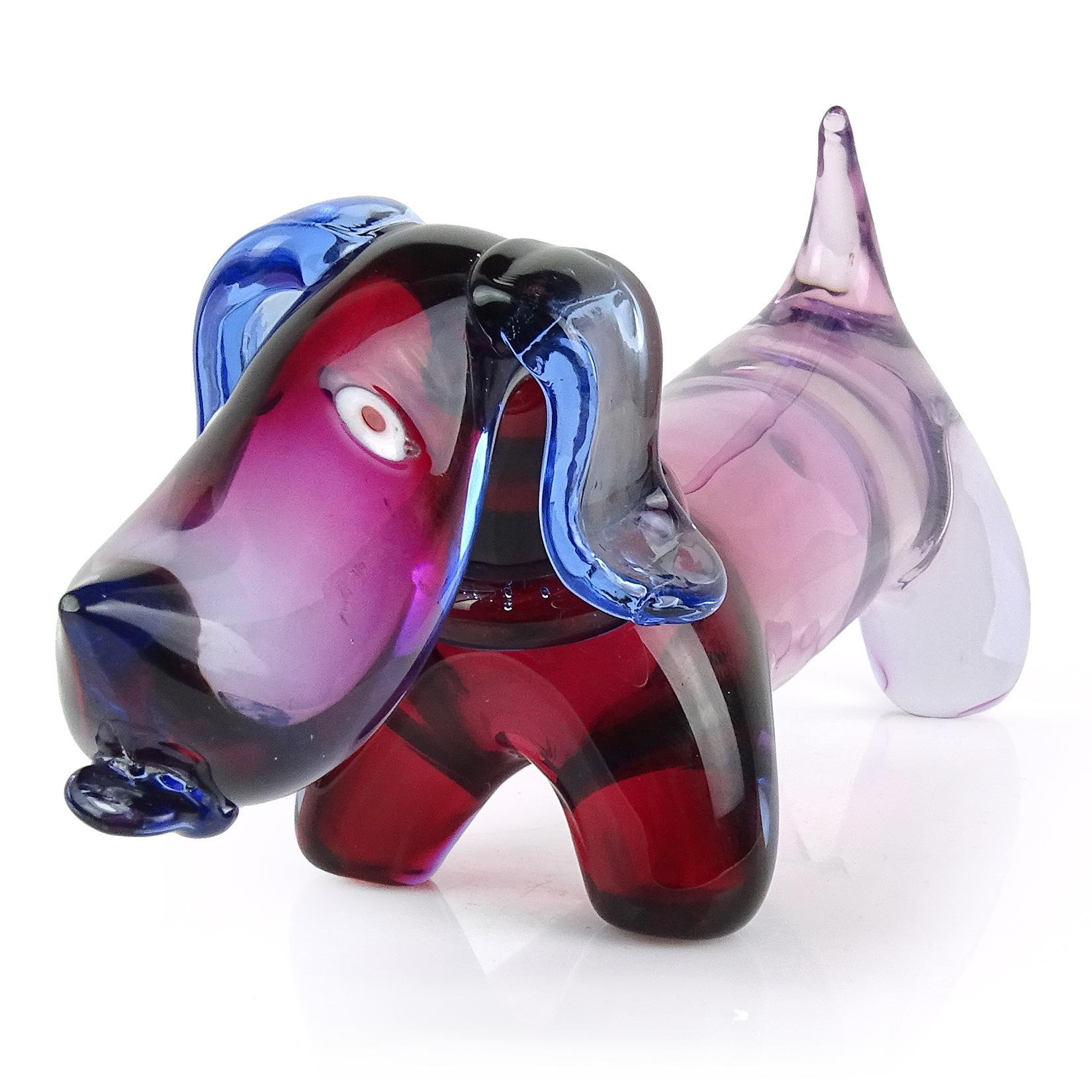 Beautiful and cute Murano hand blown Sommerso red, purple and blue Italian art glass Dachshund dog. Attributed to designer Archimede Seguso. The puppy has a blue collar, ears, and tongue sticking out. A must for the dog lover in your family.