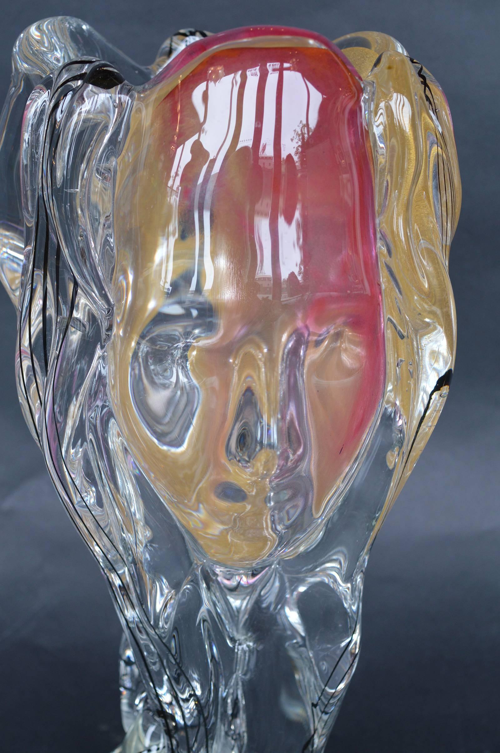 Heavy contemporary blown art glass sculptural vase by Seguso glassworks, Murano, Italy. In depiction of three faces in pink, gold flecked, and clear color. Applied atop a formed circular base.