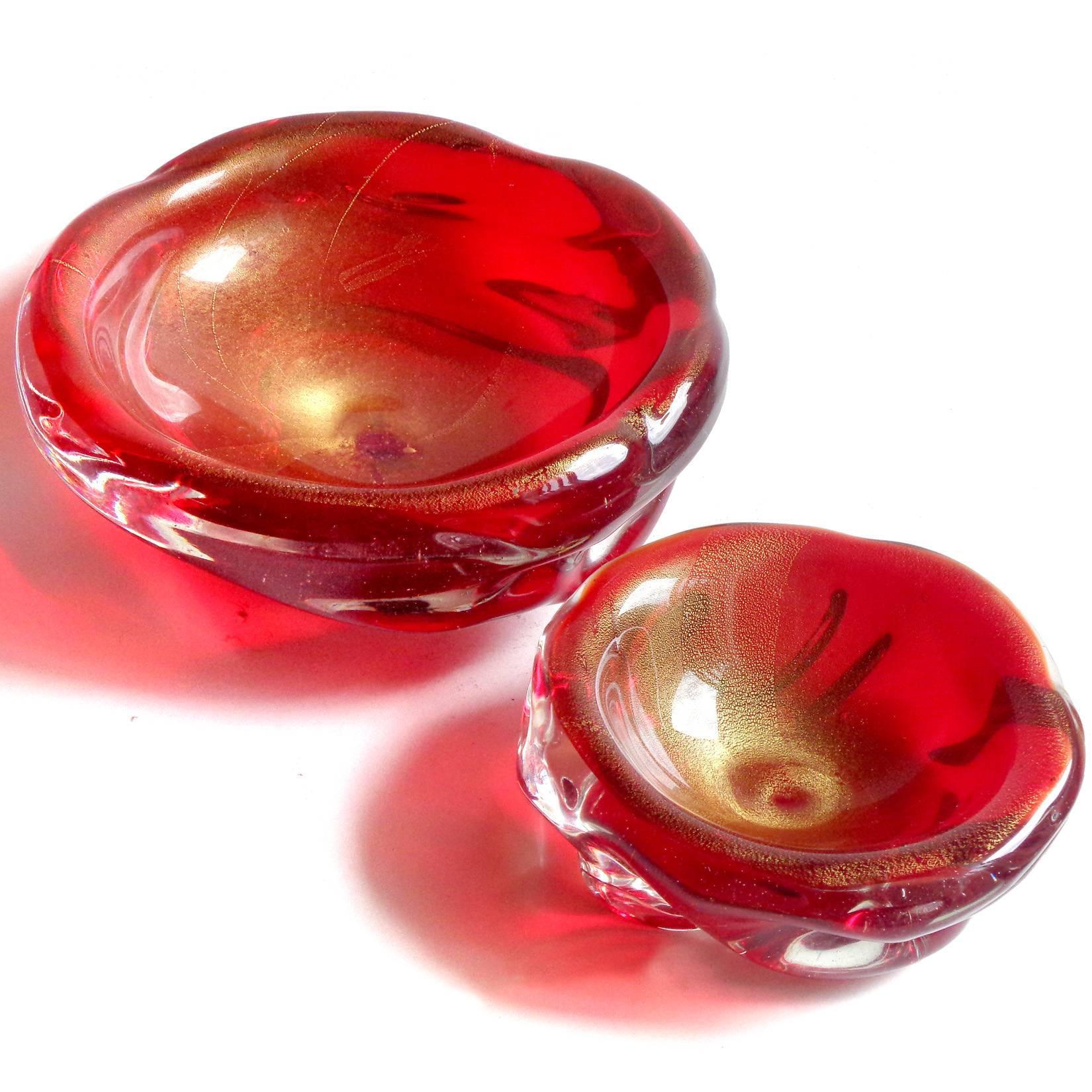 Beautiful set of vintage Murano hand blown red and gold flecks Italian art glass bowls. Attributed to designers Archimede Seguso and Flavio Poli. The smaller bowl has a partial 