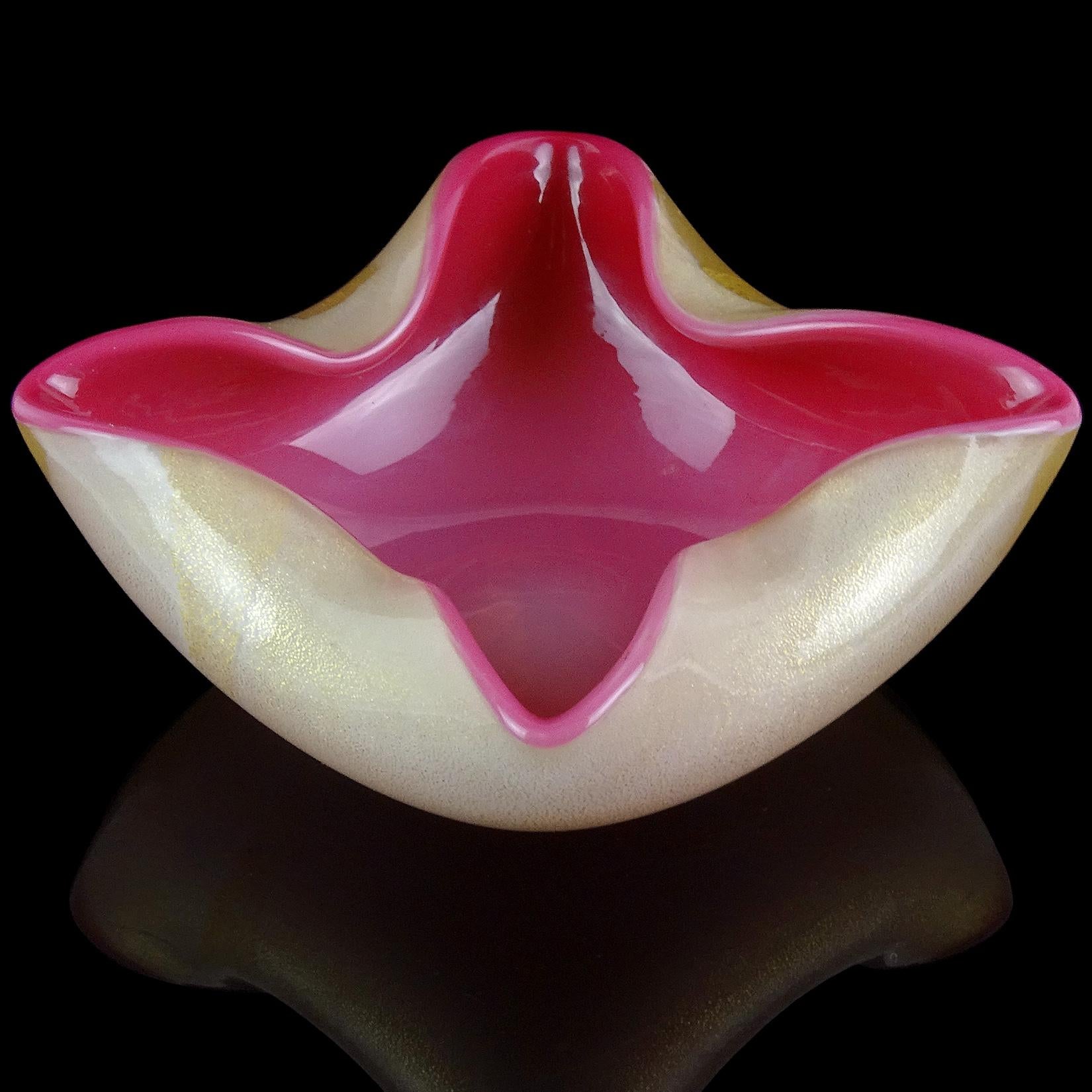 Beautiful vintage Murano hand blown white over deep pink, and gold flecks Italian art glass squared bowl, vide-poche. Attributed to the Seguso Vetri d'Arte company. It is profusely covered with gold leaf on the outside, with decorative folds on the