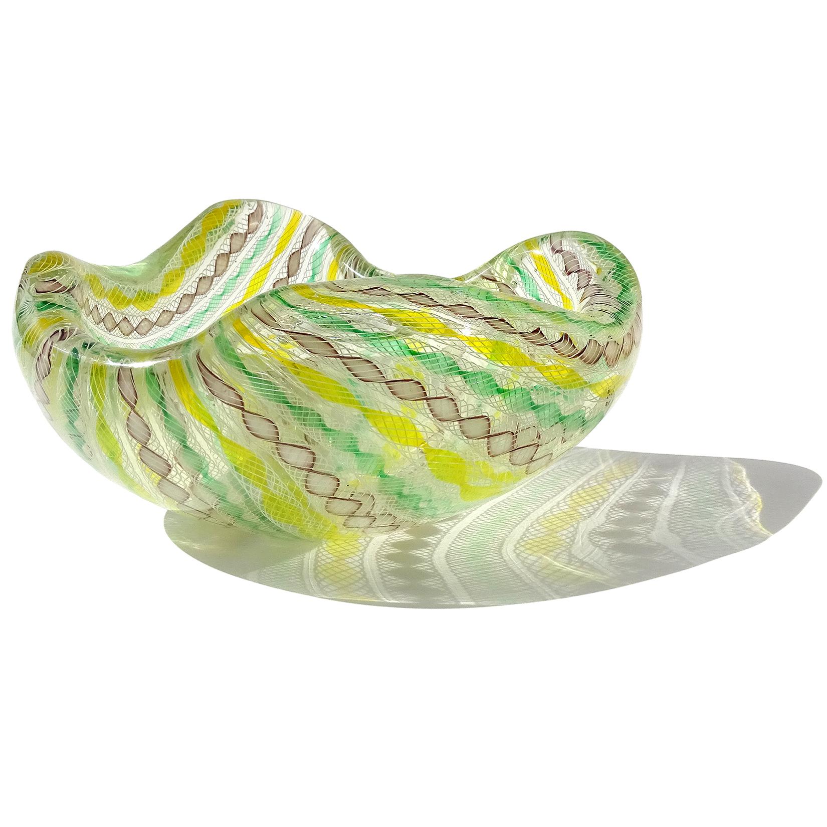 Beautiful large vintage Murano hand blown Zanfirico twisted ribbons Italian art glass bowl. Documented to designer Archimede Seguso, circa 1955. Published, as seen on the last photo. It has yellow, green, purple and white ribbon colors, with white