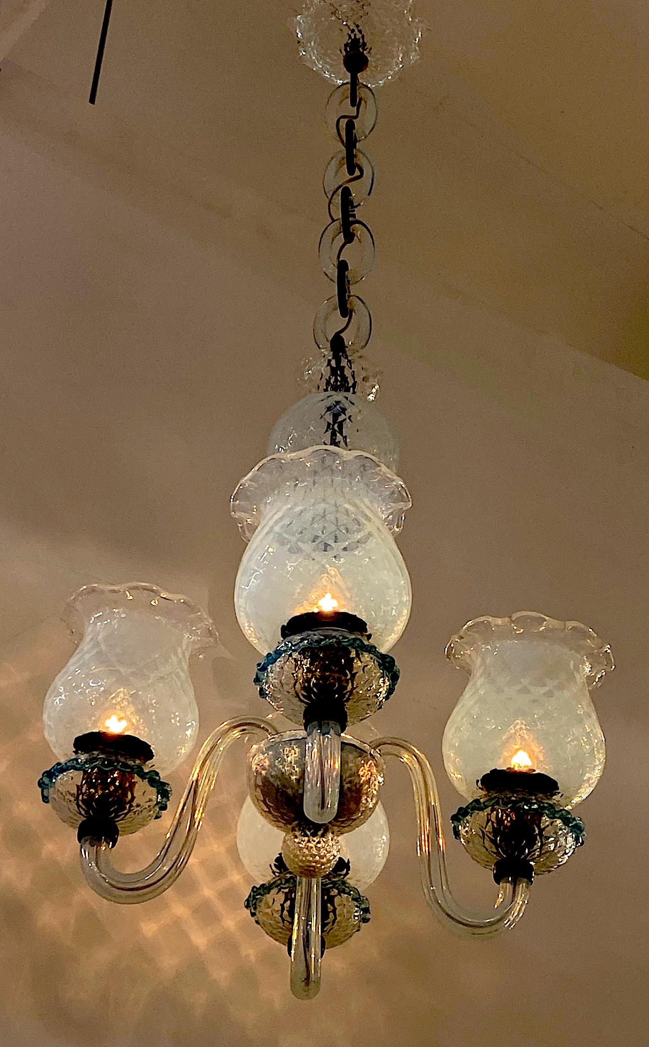 A truly beautiful example of a midcentury Italian blown glass chandelier attributed to the Seguso glass house. The chandelier is comprised of light and transparent opal color glass pieces individually hand blown. The shades and ball shape pieces