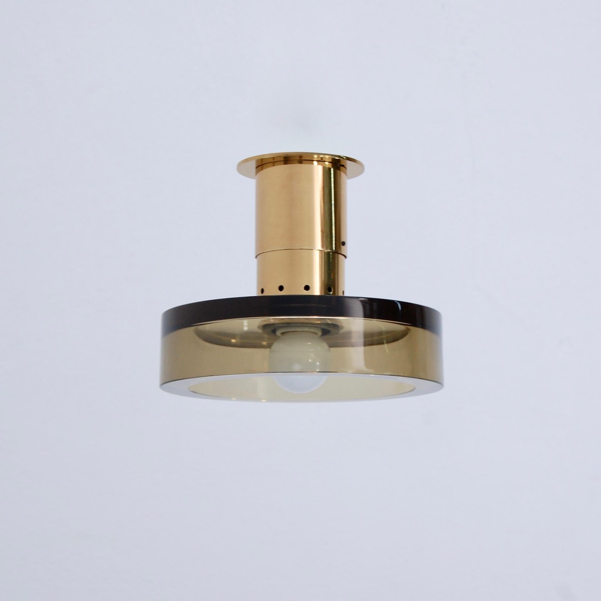 A beautiful glass and brass flush mount fixture by Seguso of Italy. Seguso glass in smoked hue. Patina lacquered brass and partially restored. Wired with a single E26 medium based socket for use in the US. Light bulb