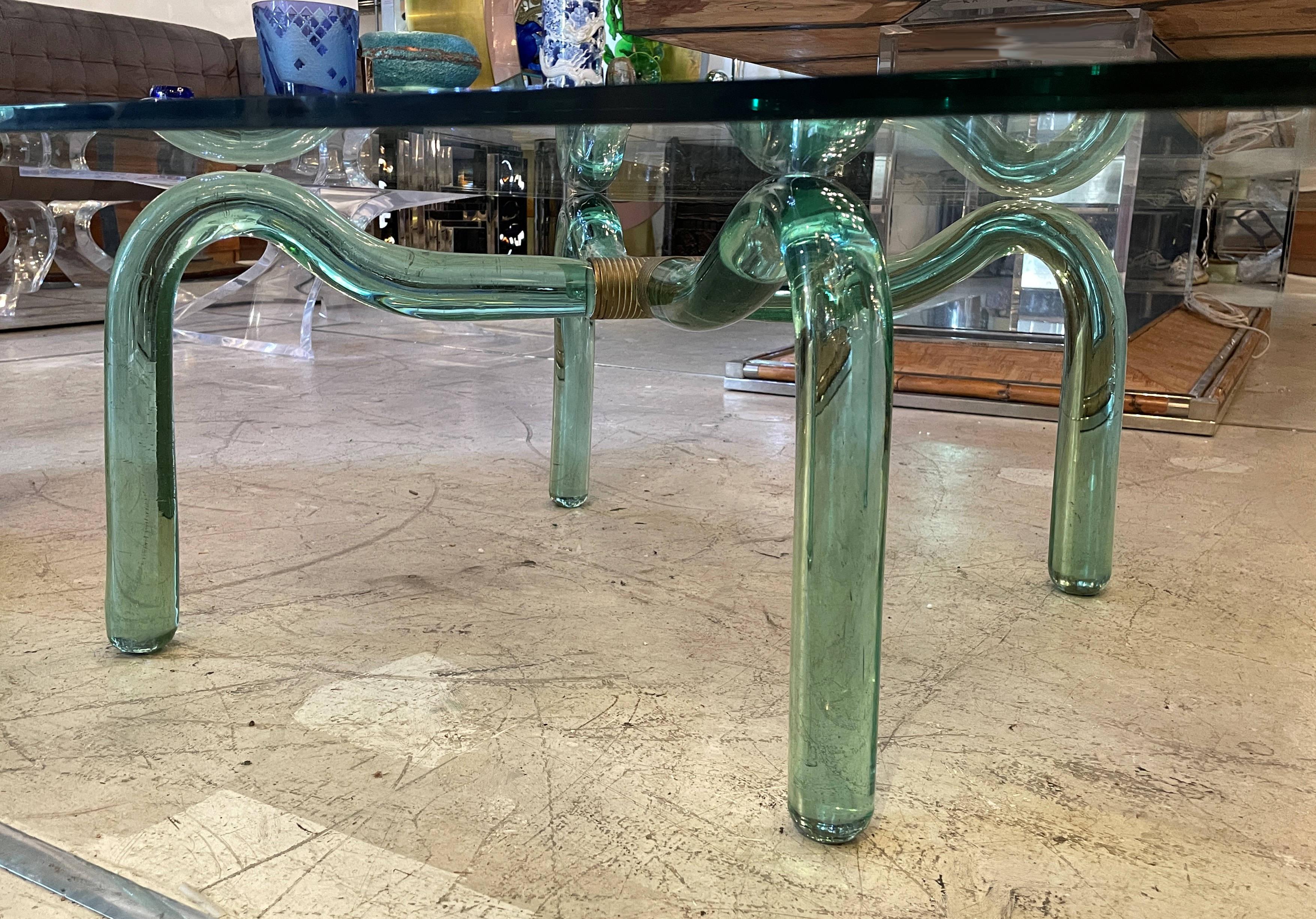 A coffee table produced by Seguso in 1950. Beautiful green cut-ground glass and brass connection. Fully original. Excellent condition. The table top is 43 inches by 43 inches and the table base is 21 inches by 21 inches.

ITALIAN,