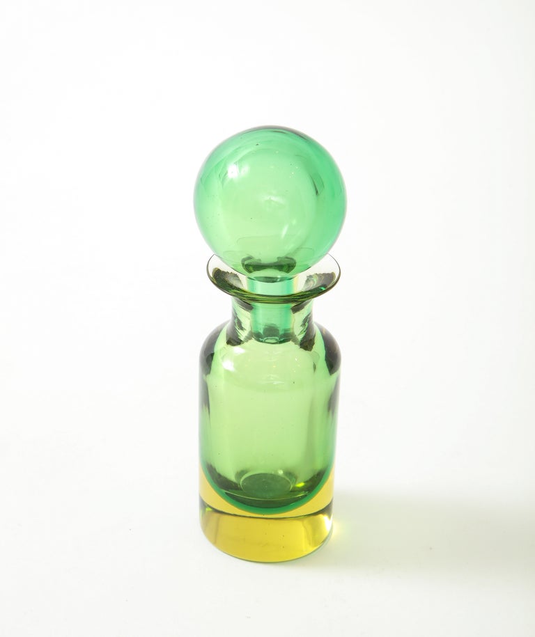 Seguso Vetri d'Arte elegant and rare glass bottle with stopper model 14150 made with Sommerso technique of glassmaking in Verde Giallo colors, Italy, circa 1969. This Murano blown glass bottle with stopper is made in graceful chartreuse green with