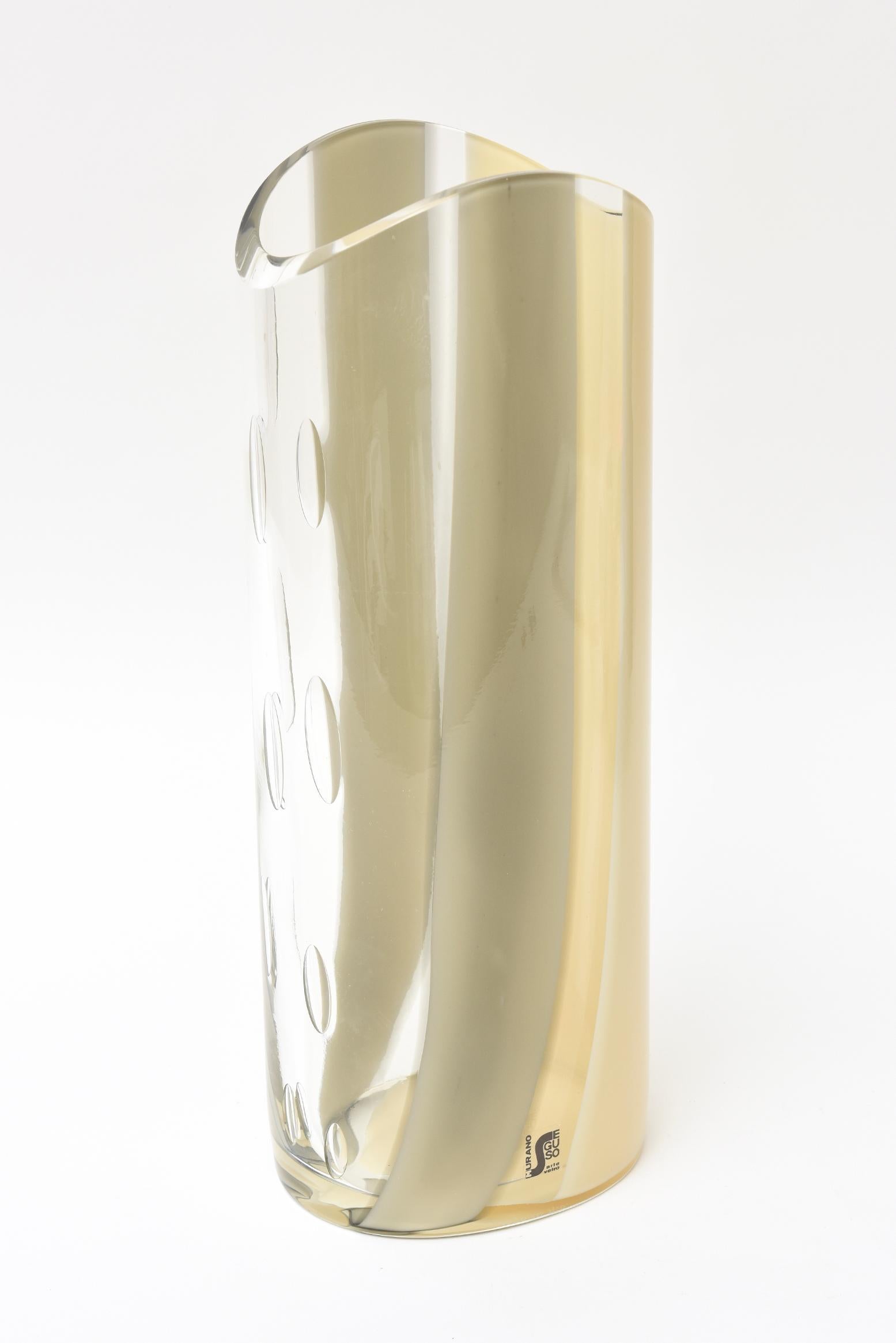 This Italian Murano signed Seguso vase is from the 1980s. The palette of cream to tan that goes to gray sweeping large stripes goes to a clear background with 10 assorted teardrop bubbles cascading the other side. The original plastic sticker
