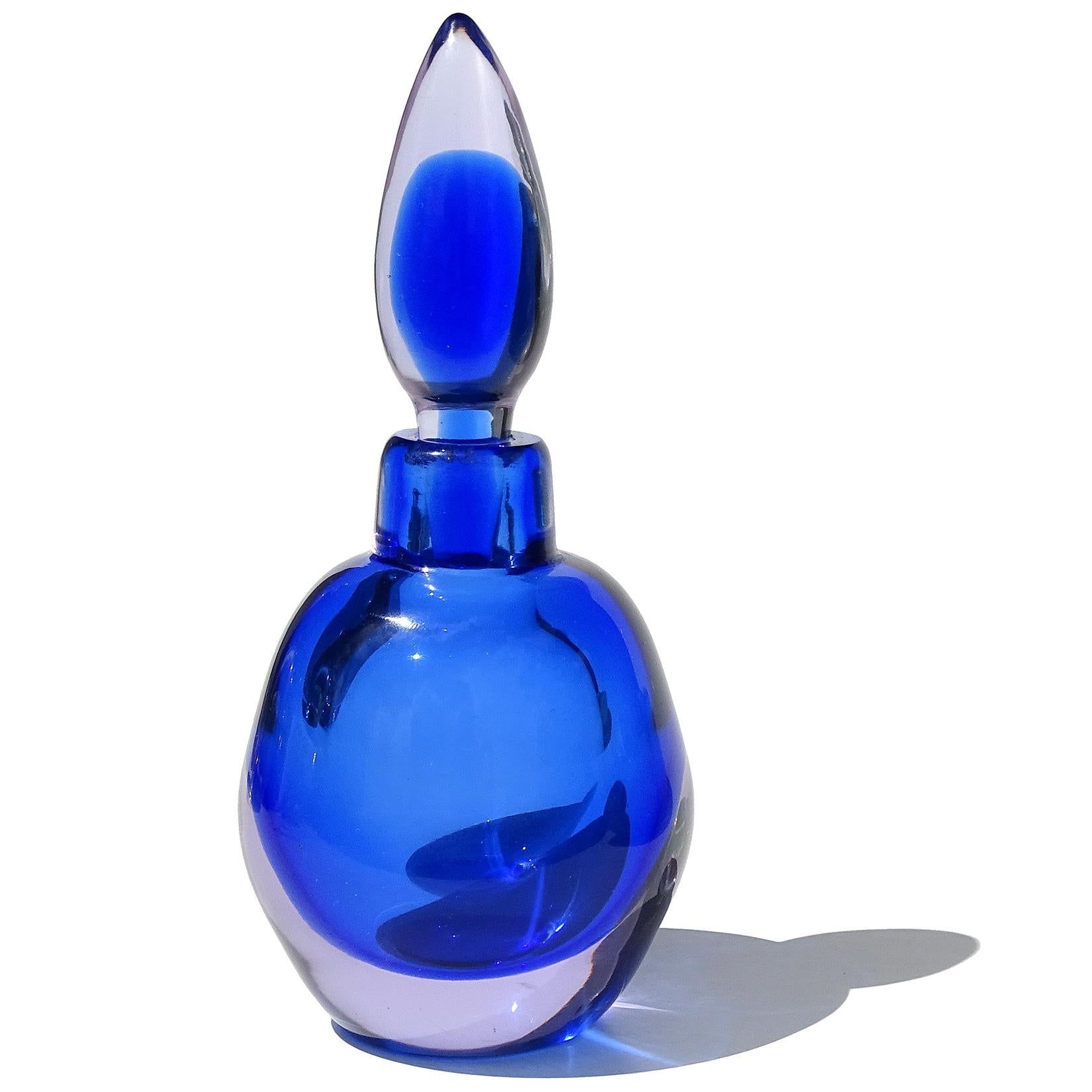 Beautiful vintage Murano hand blown Sommerso sapphire blue and light lavender Italian art glass perfume bottle. The piece is documented to the Seguso Vetri d'Arte company. It has an original tear drop stopper with it. The body of the perfume has an