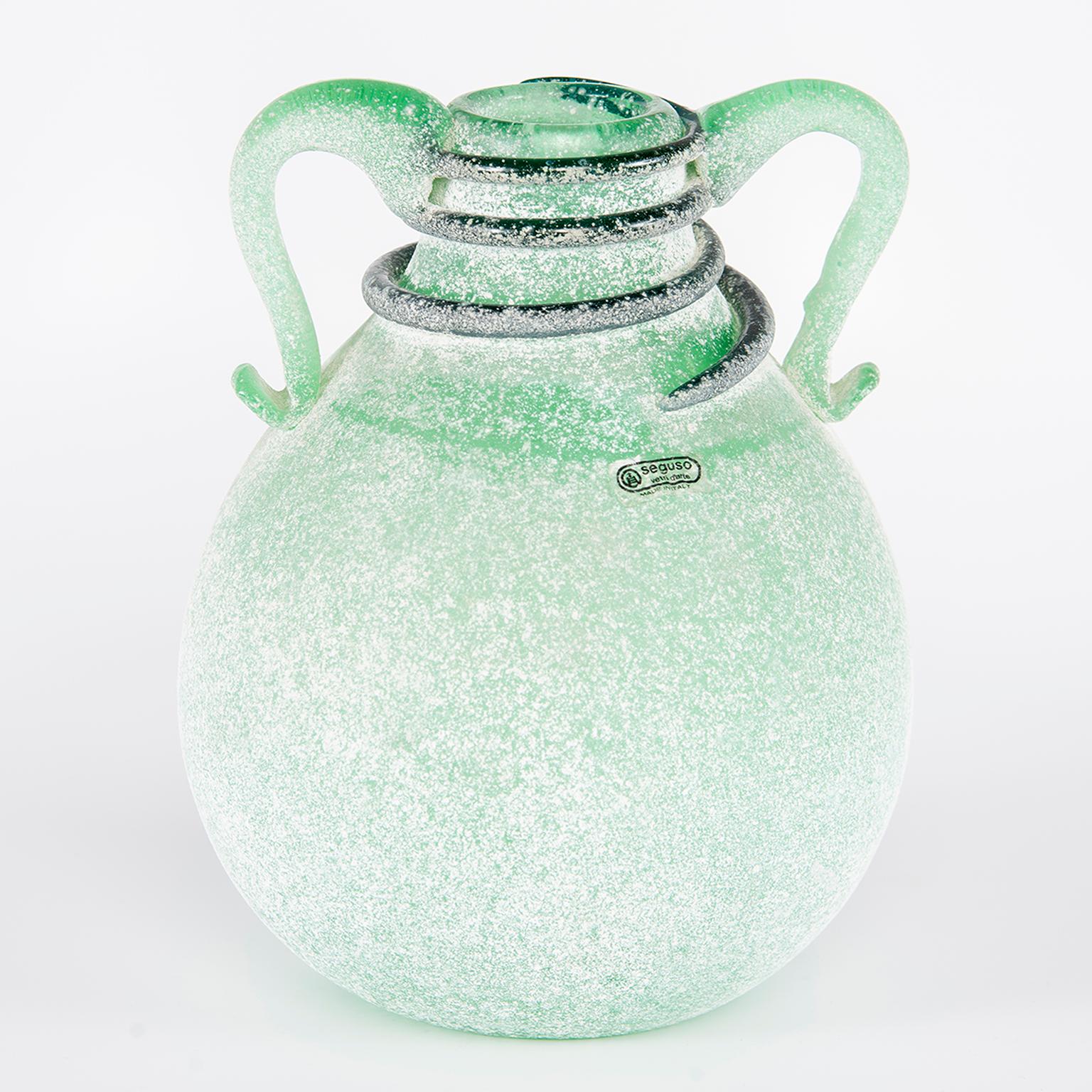 Scavo style Murano glass vase by Seguso Vetri d’Arte in bottle green color with applied handles and coiled detail at neck. Original label is affixed. Excellent vintage condition with no flaws found, circa 1970s.