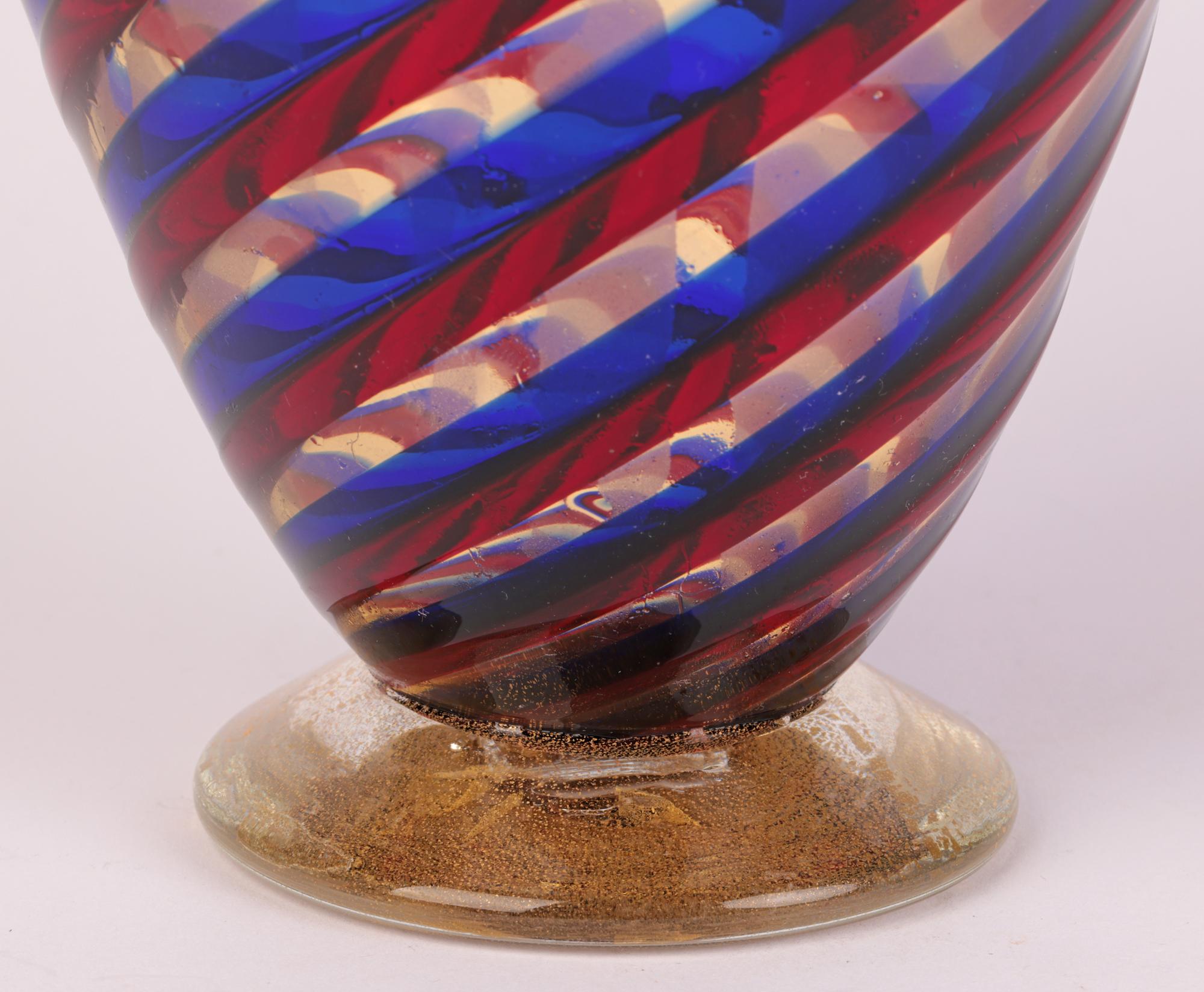 A very fine quality and stunning Italian Murano ribbon blown art glass vase attributed to Seguso Vetri d’Arte and probably dating from the mid-20th century. The hand-blown vase stands on a narrow solid round pedestal base in clear glass enclosing