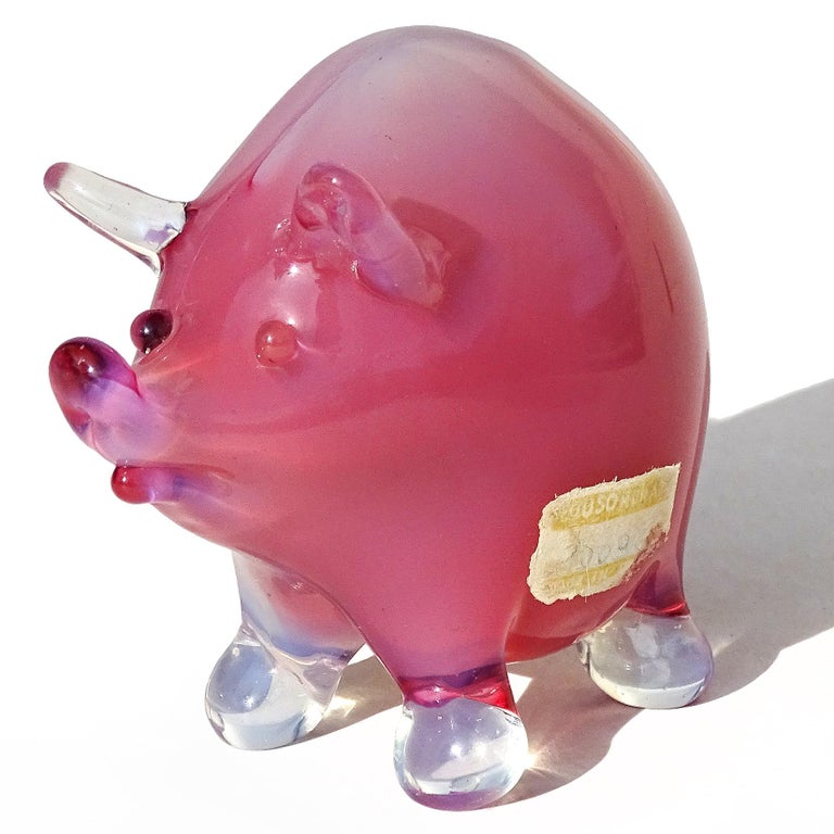 Beautiful vintage Murano hand blown clear over opalescent pink Italian art glass little pig figurine. Documented to the Seguso Vetri d'Arte company. The sculpture has a partial label still attached to the side, which reads 