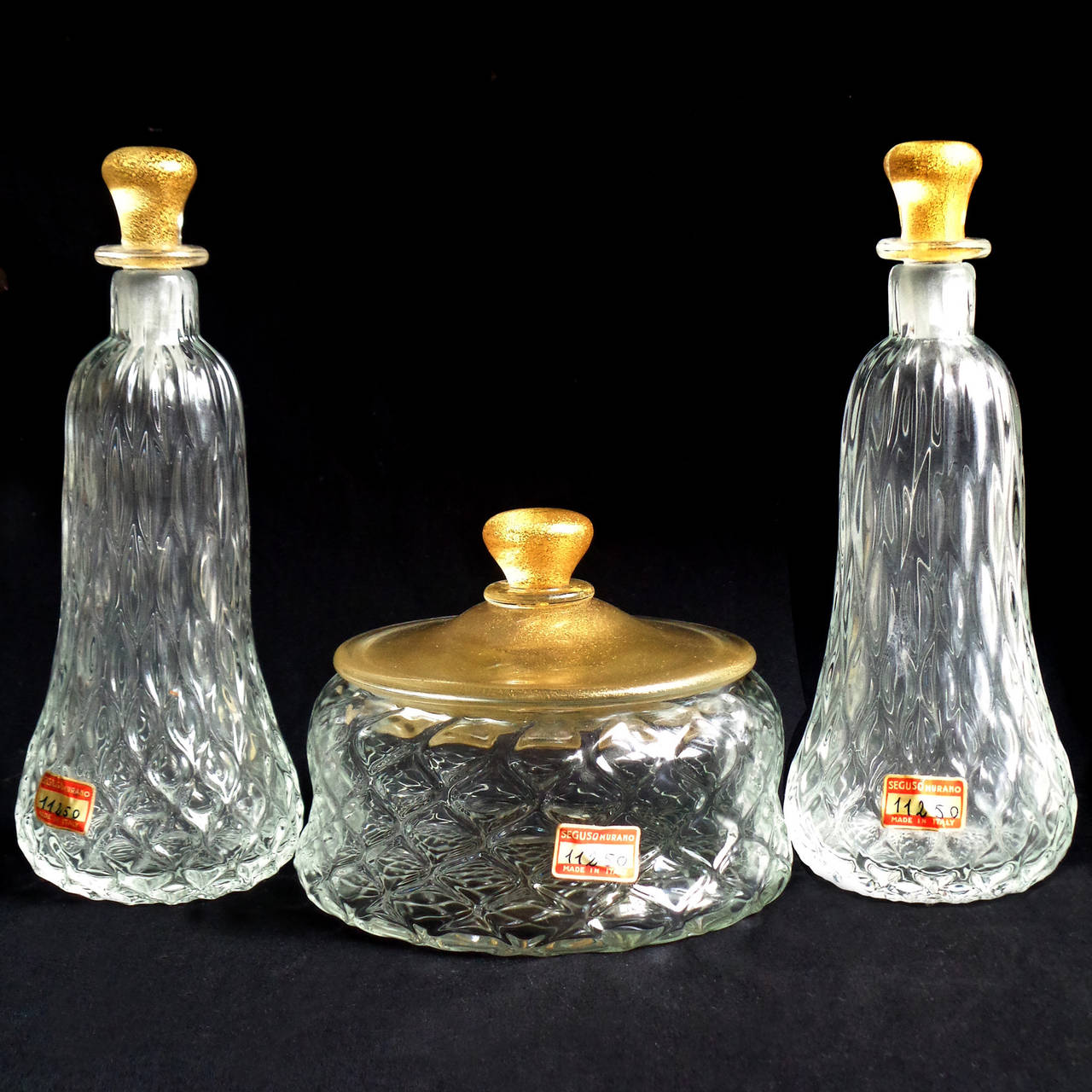 Rare and beautiful, vintage Murano hand blown crystal clear, diamond quilted design and gold accents Italian art glass powder box and perfume bottle set. Documented to designer Flavio Poli for Seguso Vetri d'Arte, published. Each with the