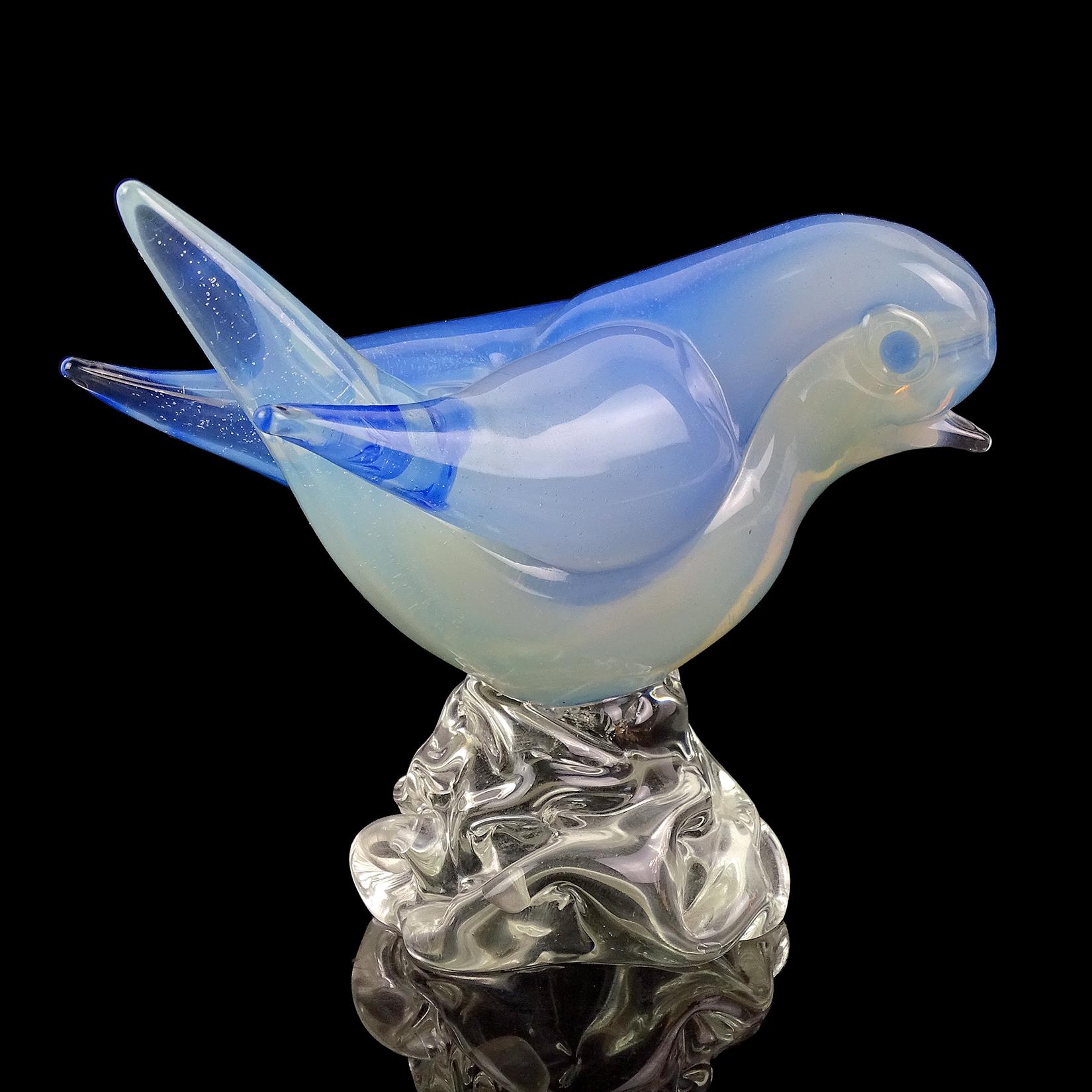 Beautiful vintage Murano hand blown Sommerso opalescent white and sky blue Italian art glass bird figurine / sculpture. Documented to the Seguso Vetri d'Arte company, circa 1950s. The cute bird has applied blue eyes, and stands on a clear glass rock