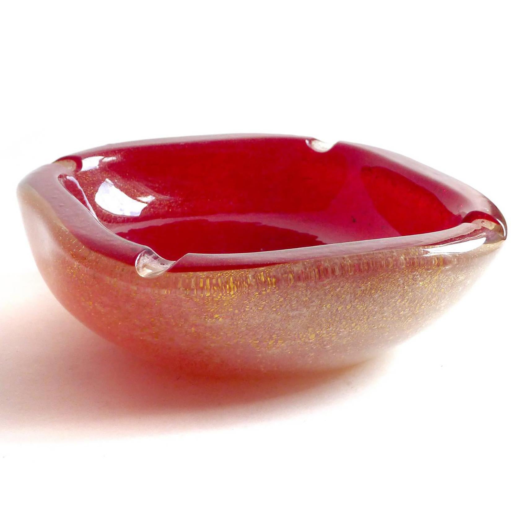 Beautiful vintage Murano hand blown ruby red, bubbles and gold flecks Italian art glass ashtray / bowl. The piece is documented to the Seguso Vetri D' Arte company, circa 1940s. Similars have been published in the company catalogs and books. It is
