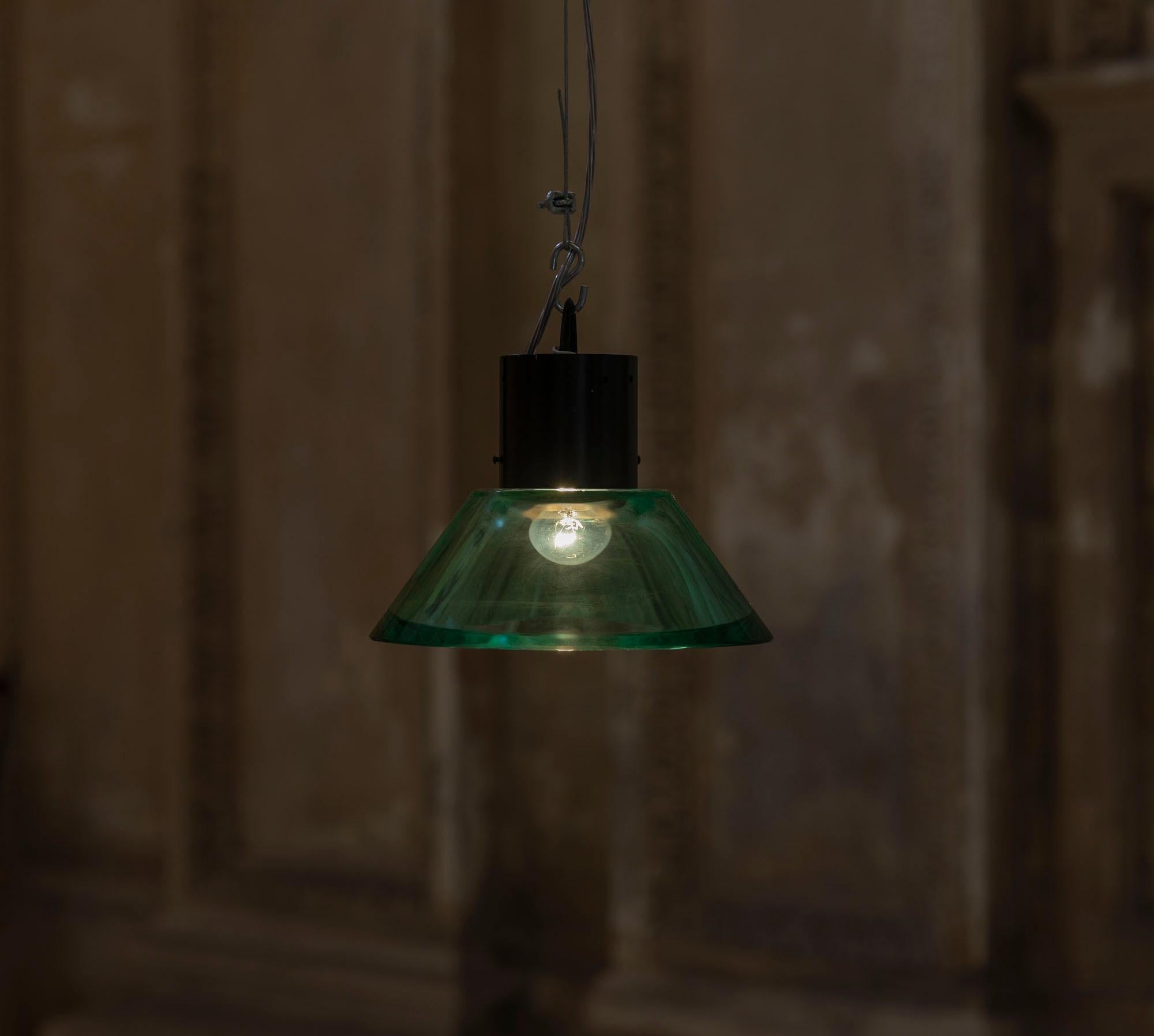 Stunning Italian midcentury pendant by Seguso.
Green solid thick Murano glass and black painted brass structure.