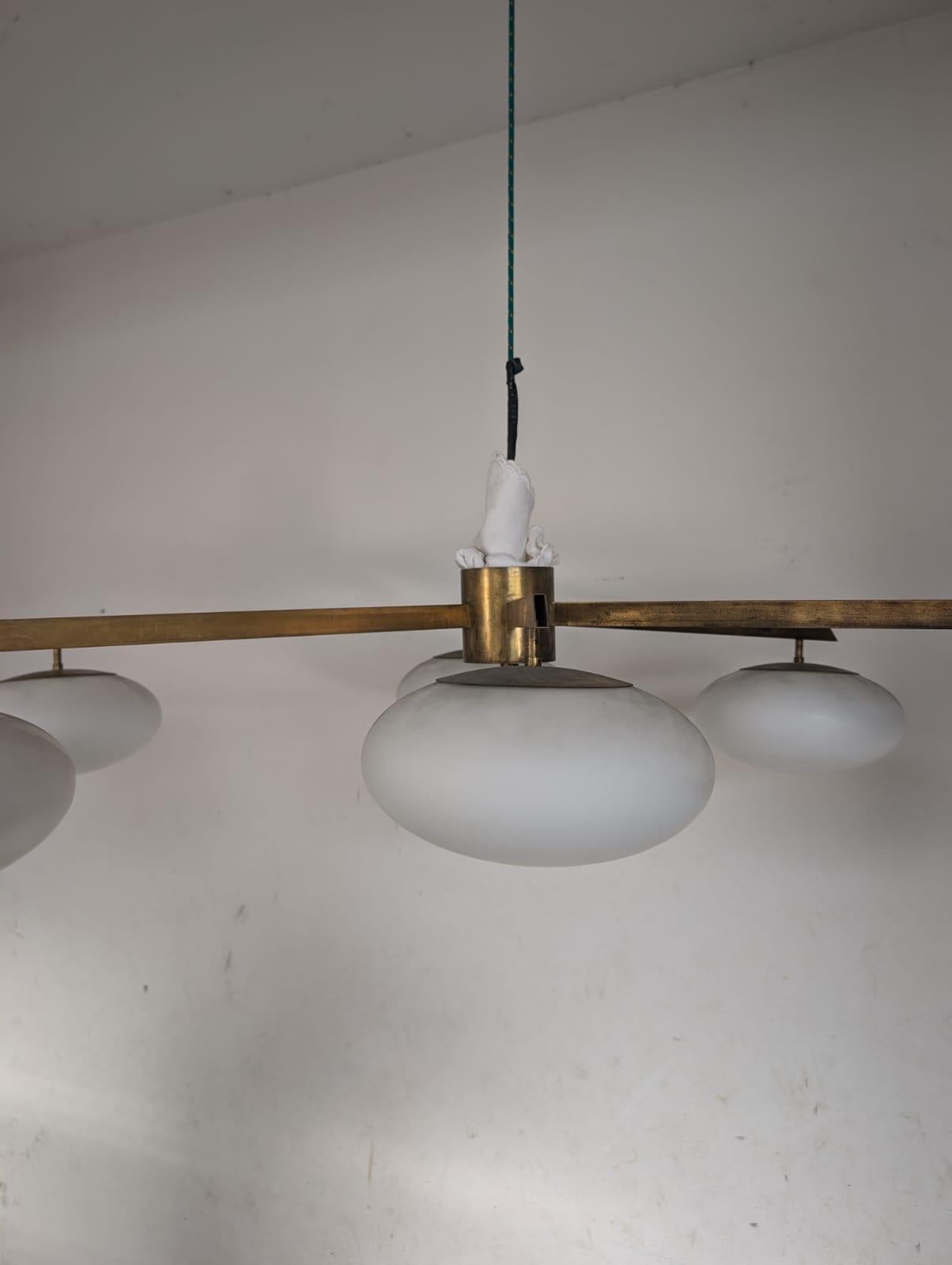 The Sei Lune (Six Moons) Ceiling Light is a remarkable creation by the famous designer Angelo Lelii, founder of the iconic Italian lighting firm, Arredoluce. This piece is a creation from the 1960s. The ceiling light structure is made from brass,