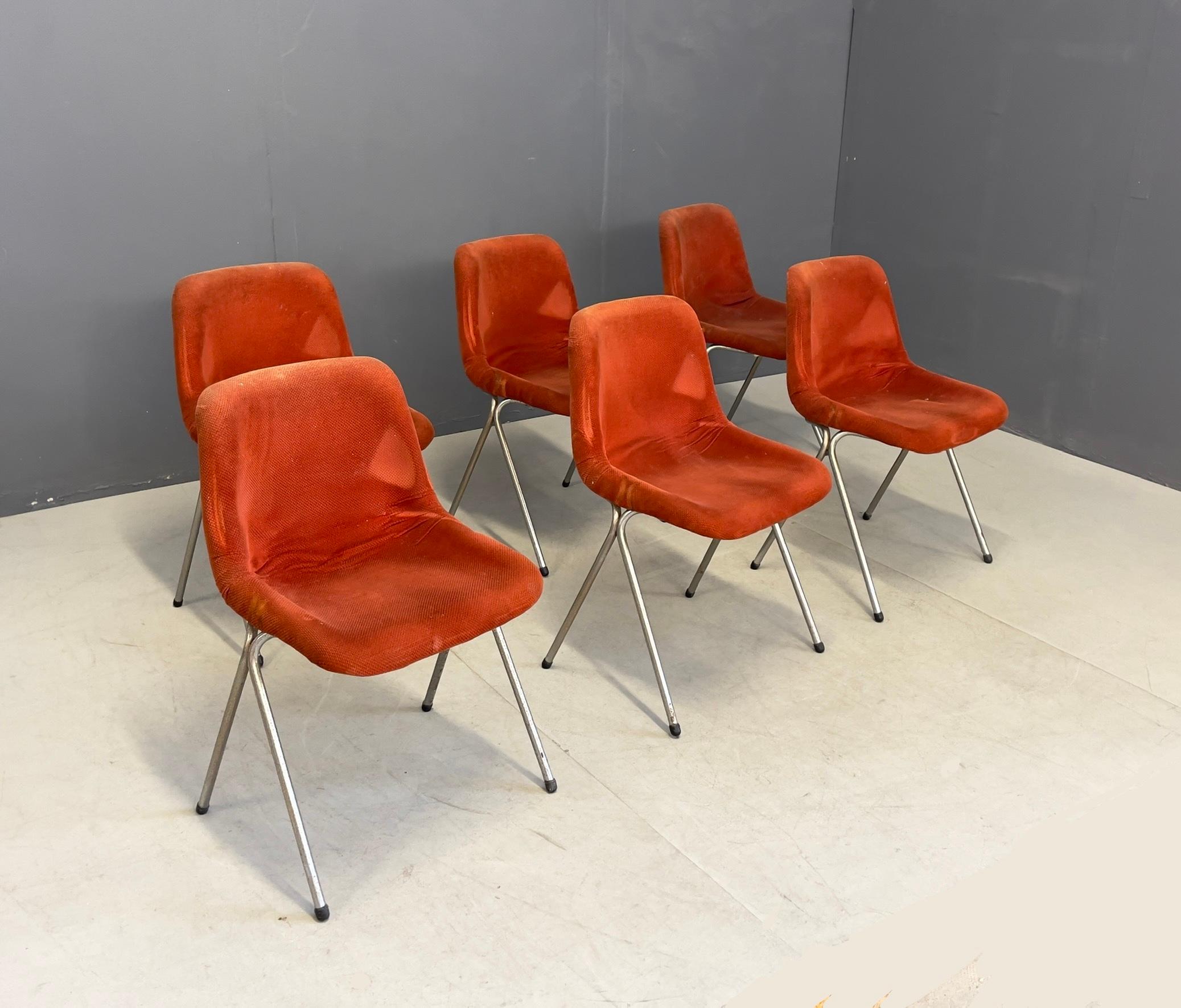 Six chairs with chromed metal frame, plastic material, and red fabric upholstery. Italian manufacture. 1960s.