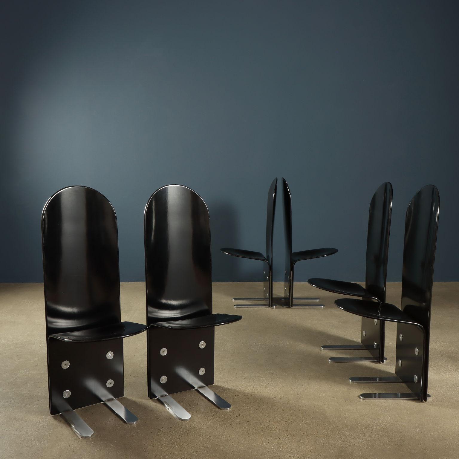 Group of black lacquered wood chairs with chrome-plated steel feet with exposed screws and washers for attachment. Very good conditions
