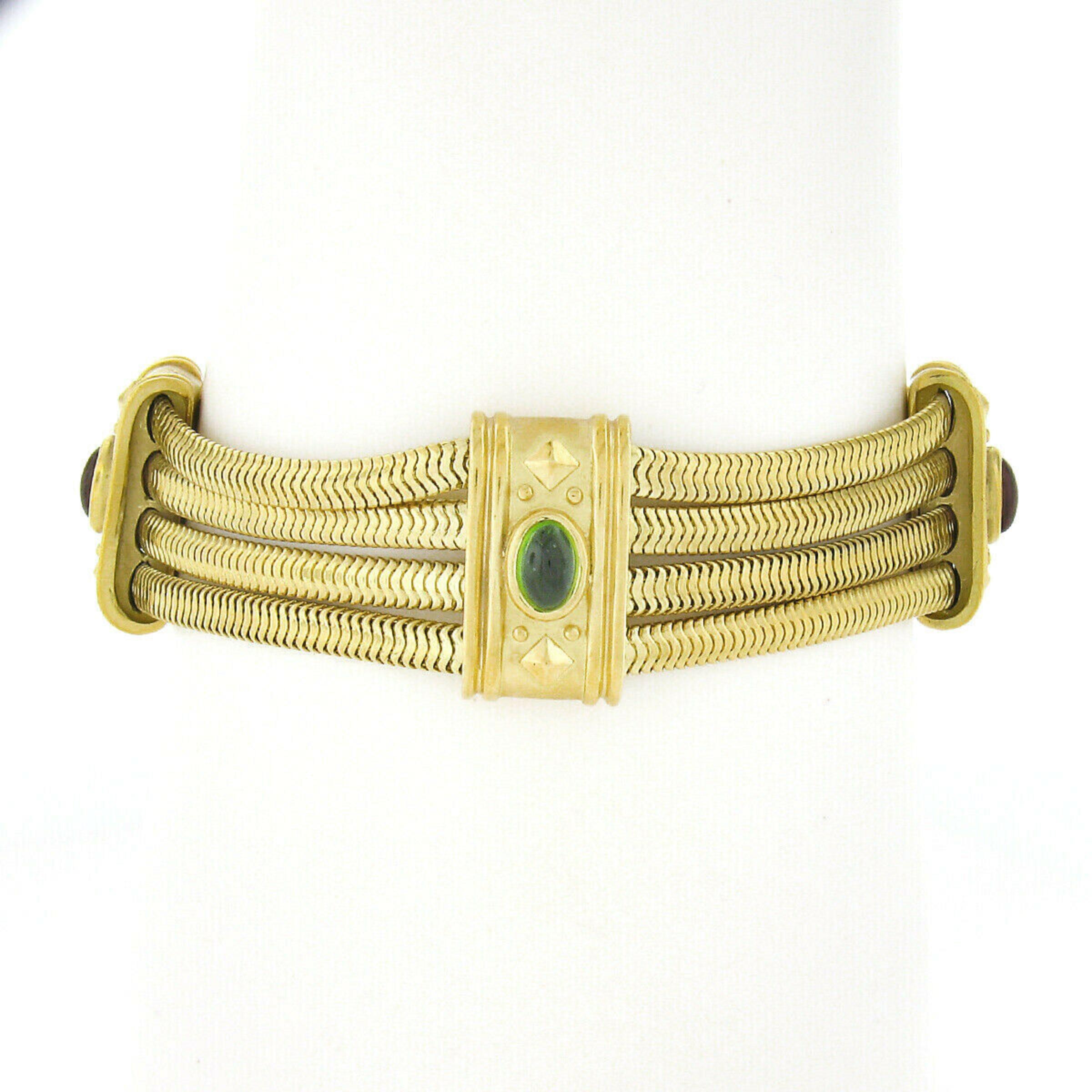 Here we have an elegant statement bracelet designed by SeidenGang that is very well crafted from solid 18k yellow gold. It features 4 rows of snake chain with 4 panels equally spaced throughout in which each are neatly bezel set with a fine